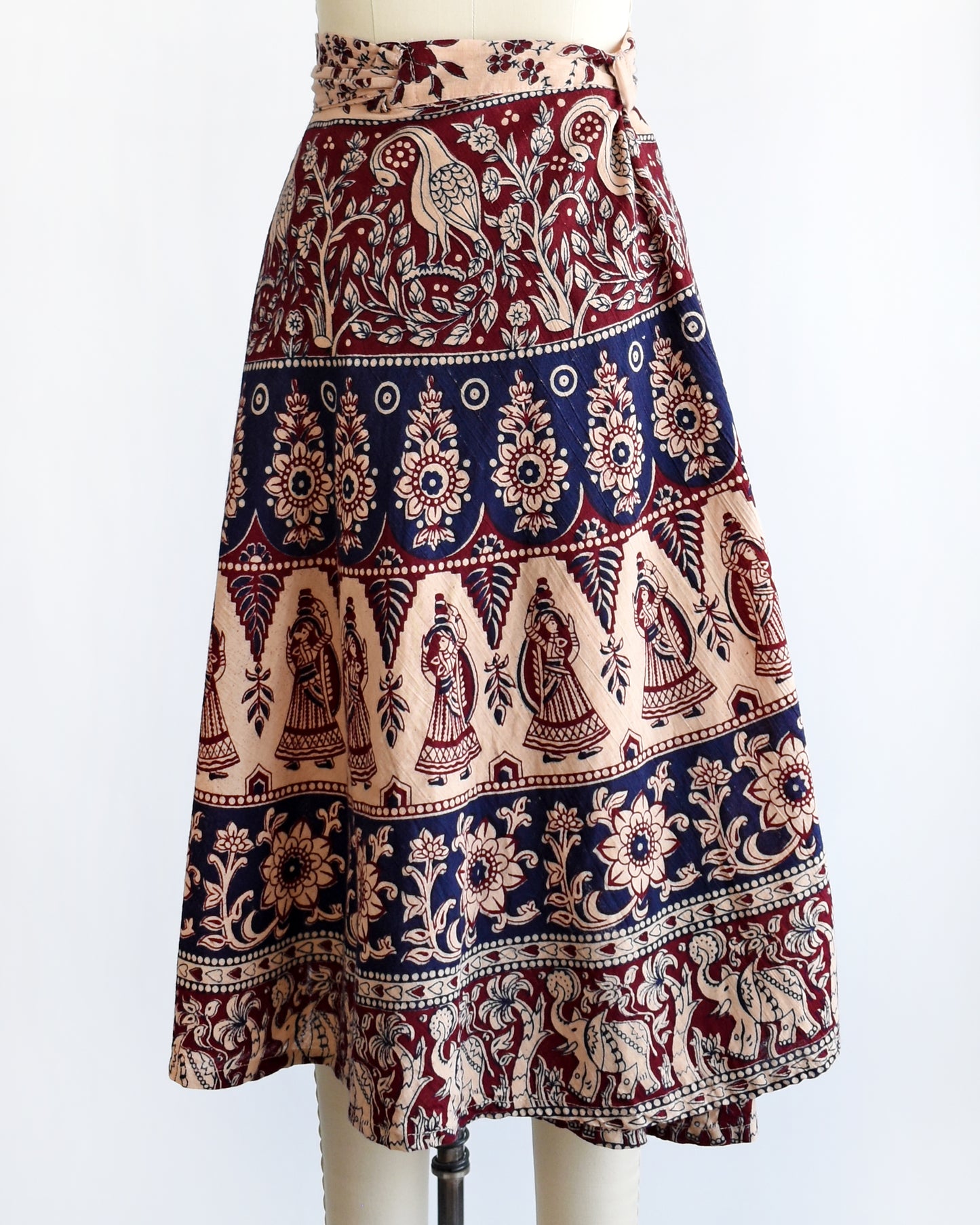 back view of a vintage 1970s block print skirt on a mannequin against a white background