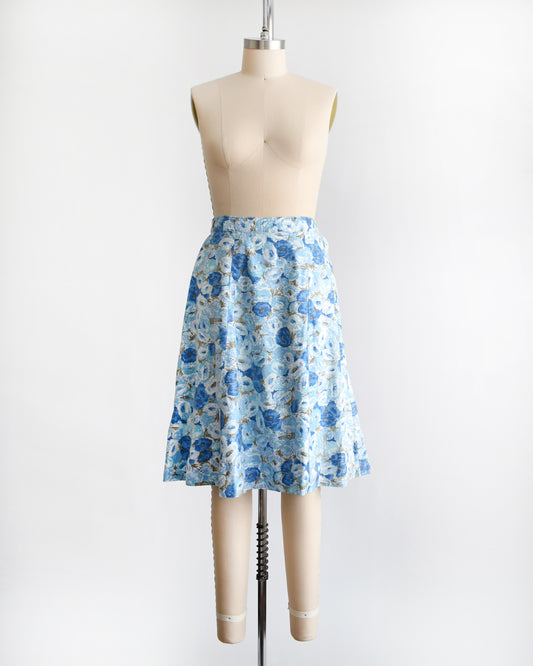 a vintage blue floral skirt on a mannequin against a white background