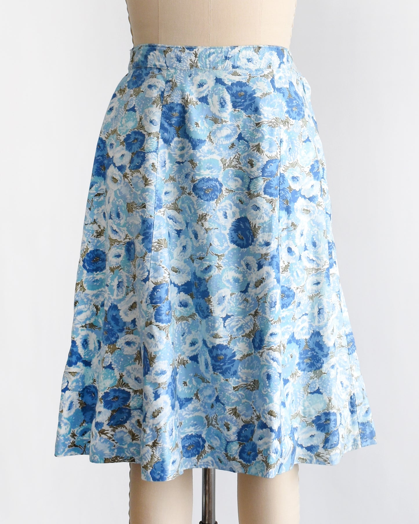 a vintage blue floral skirt on a mannequin against a white background