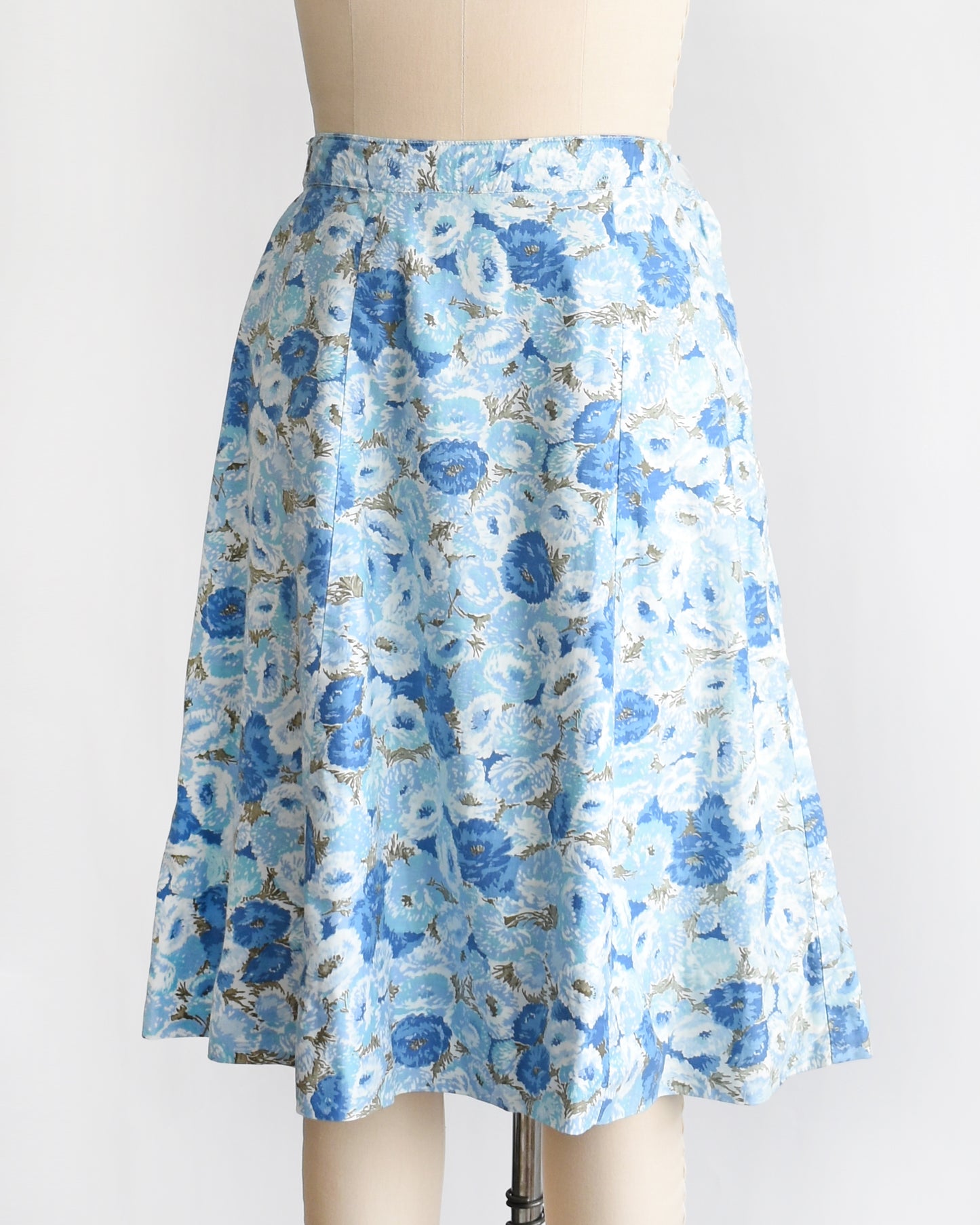 side front view of a vintage blue floral skirt on a mannequin against a white background