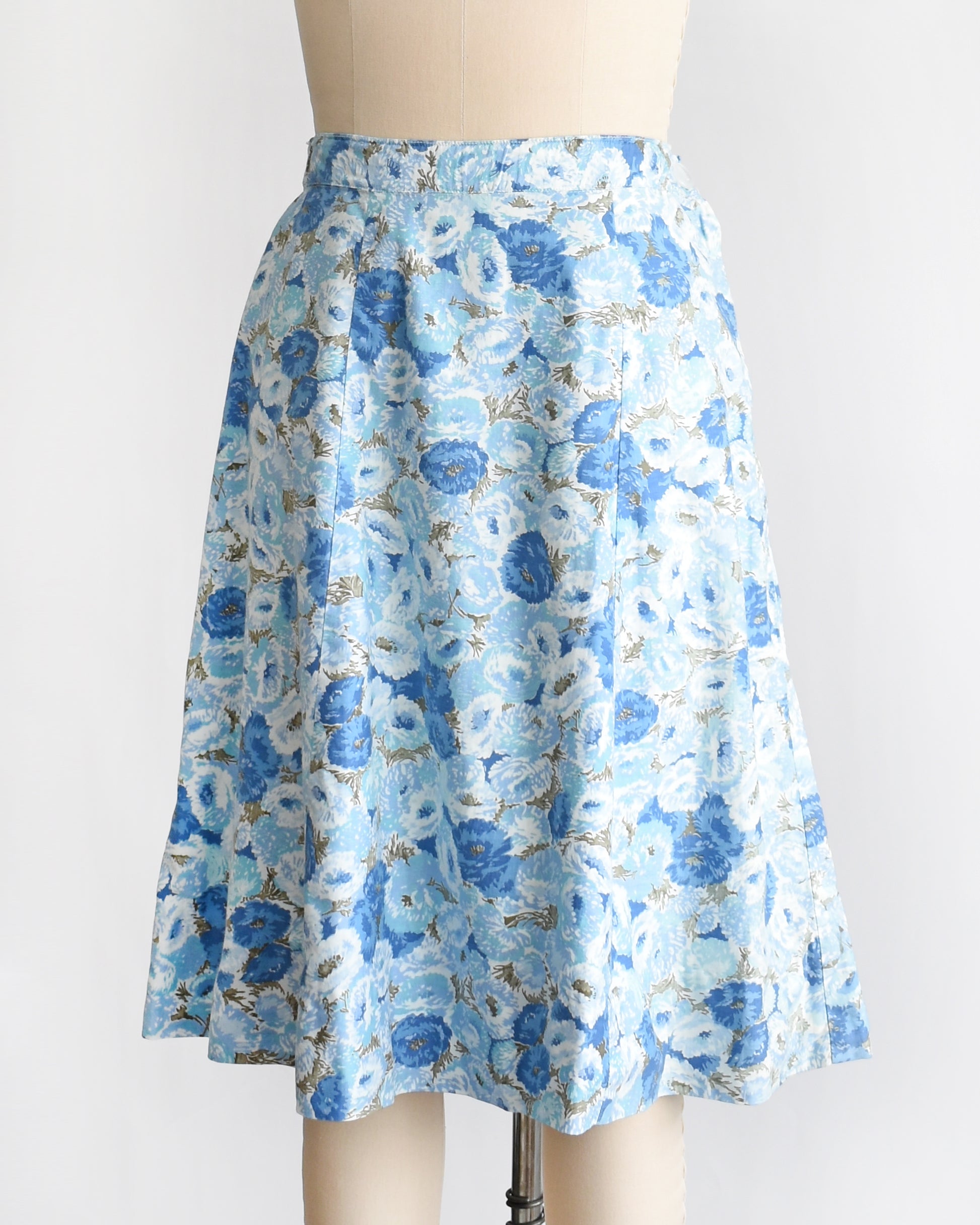 side front view of a vintage blue floral skirt on a mannequin against a white background