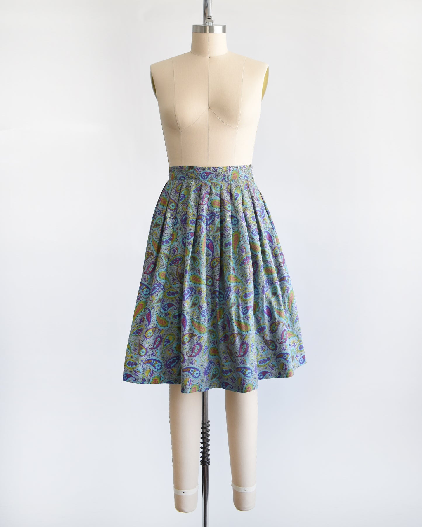 a vintage 1950s floral paisley skirt on a mannequin against a white background