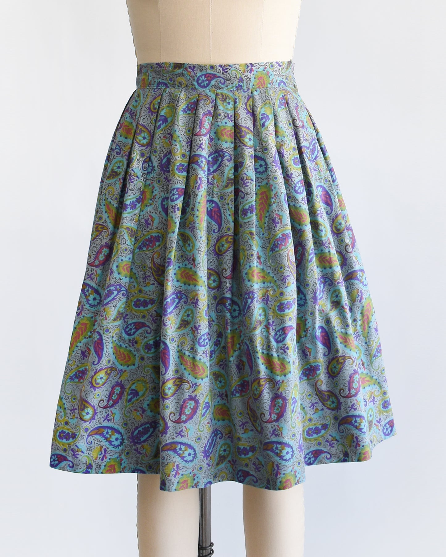 a vintage 1950s floral paisley skirt on a mannequin against a white background