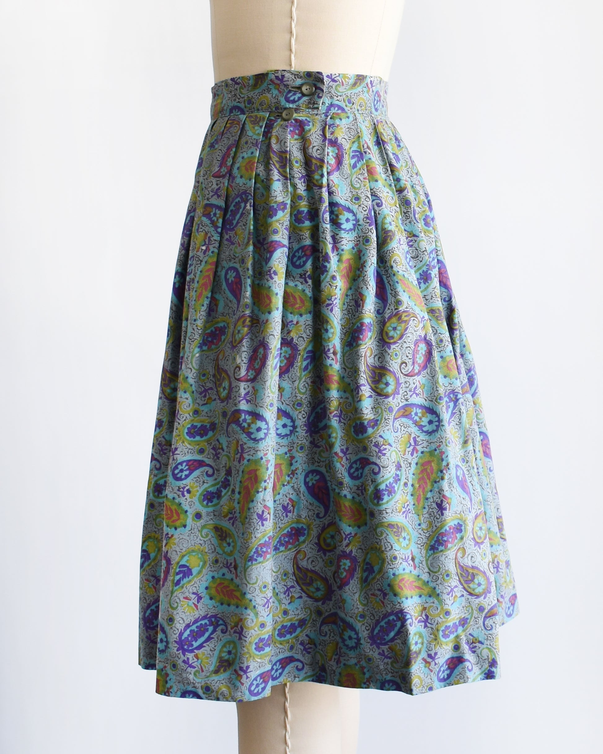 side view of a vintage 1950s floral paisley skirt on a mannequin against a white background