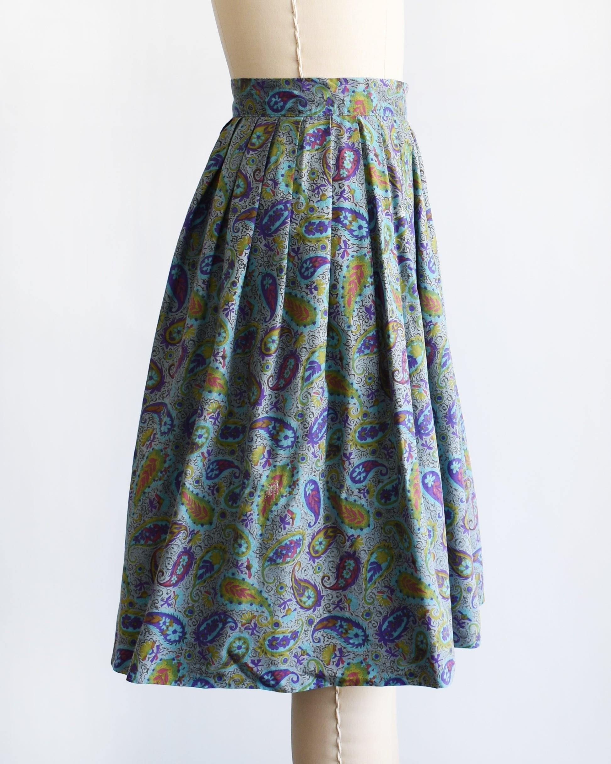 side view of a vintage 1950s floral paisley skirt on a mannequin against a white background