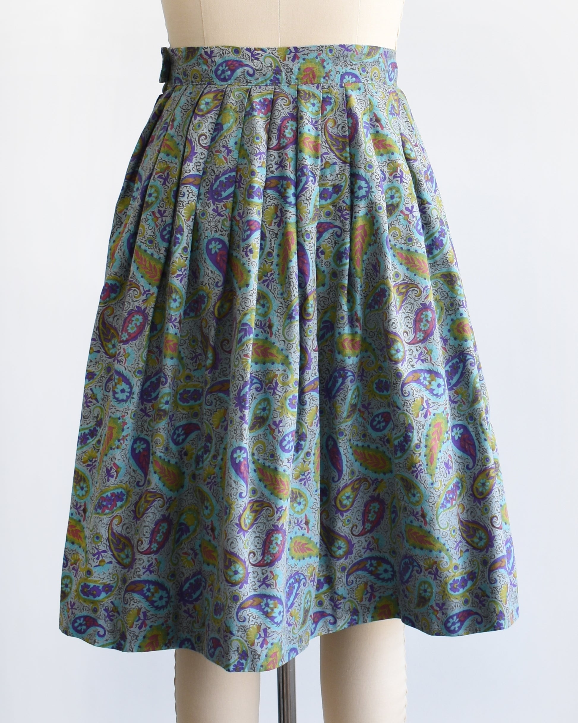 back view of a vintage 1950s floral paisley skirt on a mannequin against a white background