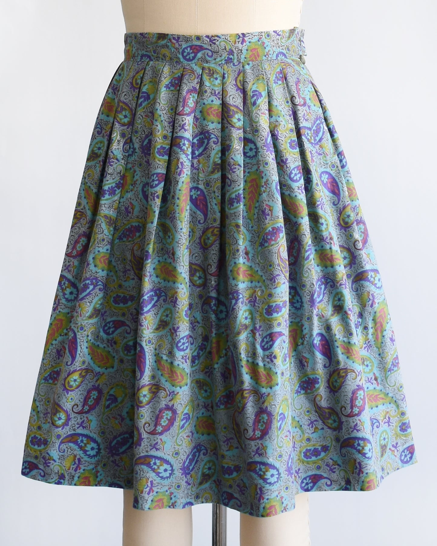side front view of a vintage 1950s floral paisley skirt on a mannequin against a white background