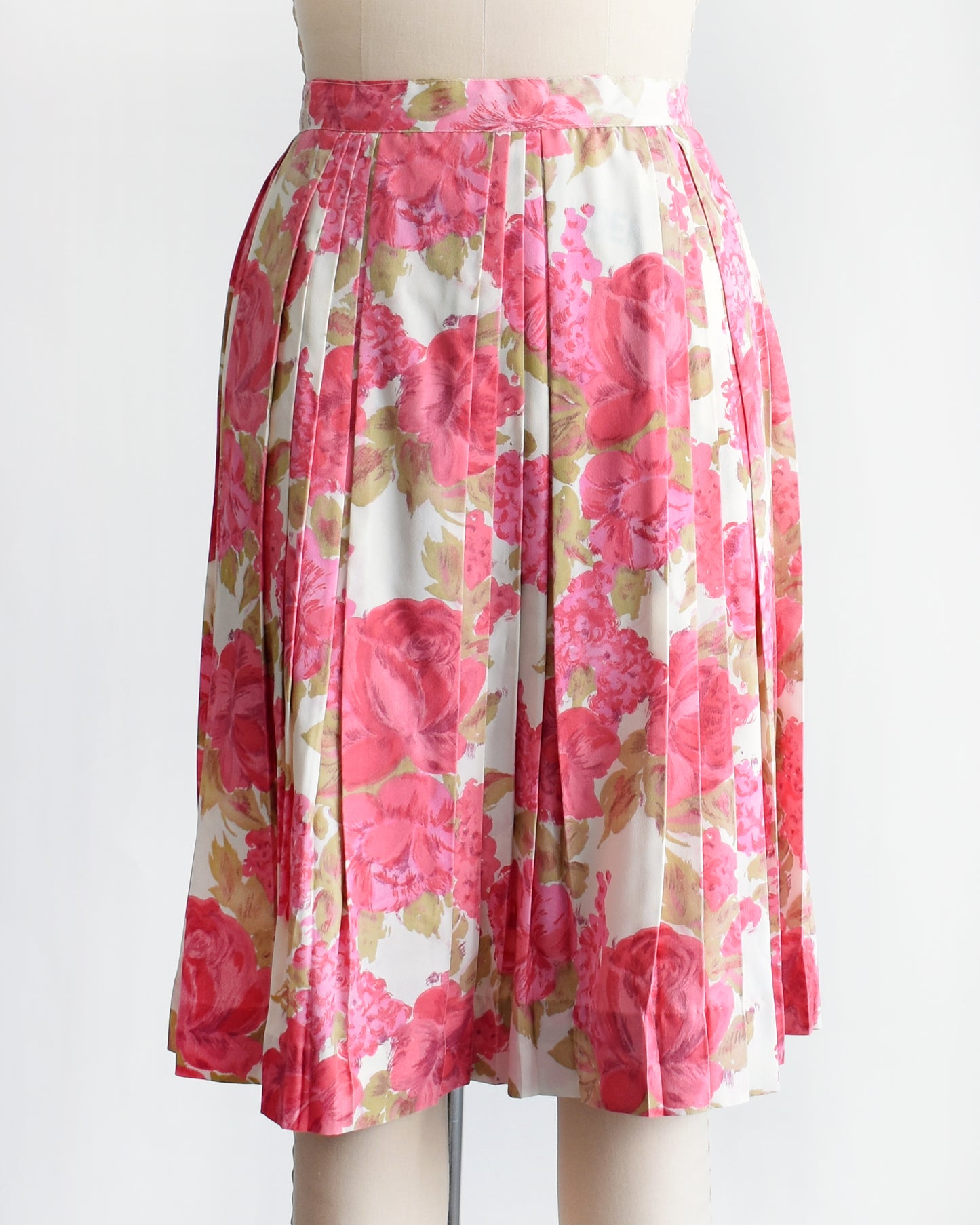 a vintage 1950s pink floral skirt on a mannequin against a white background