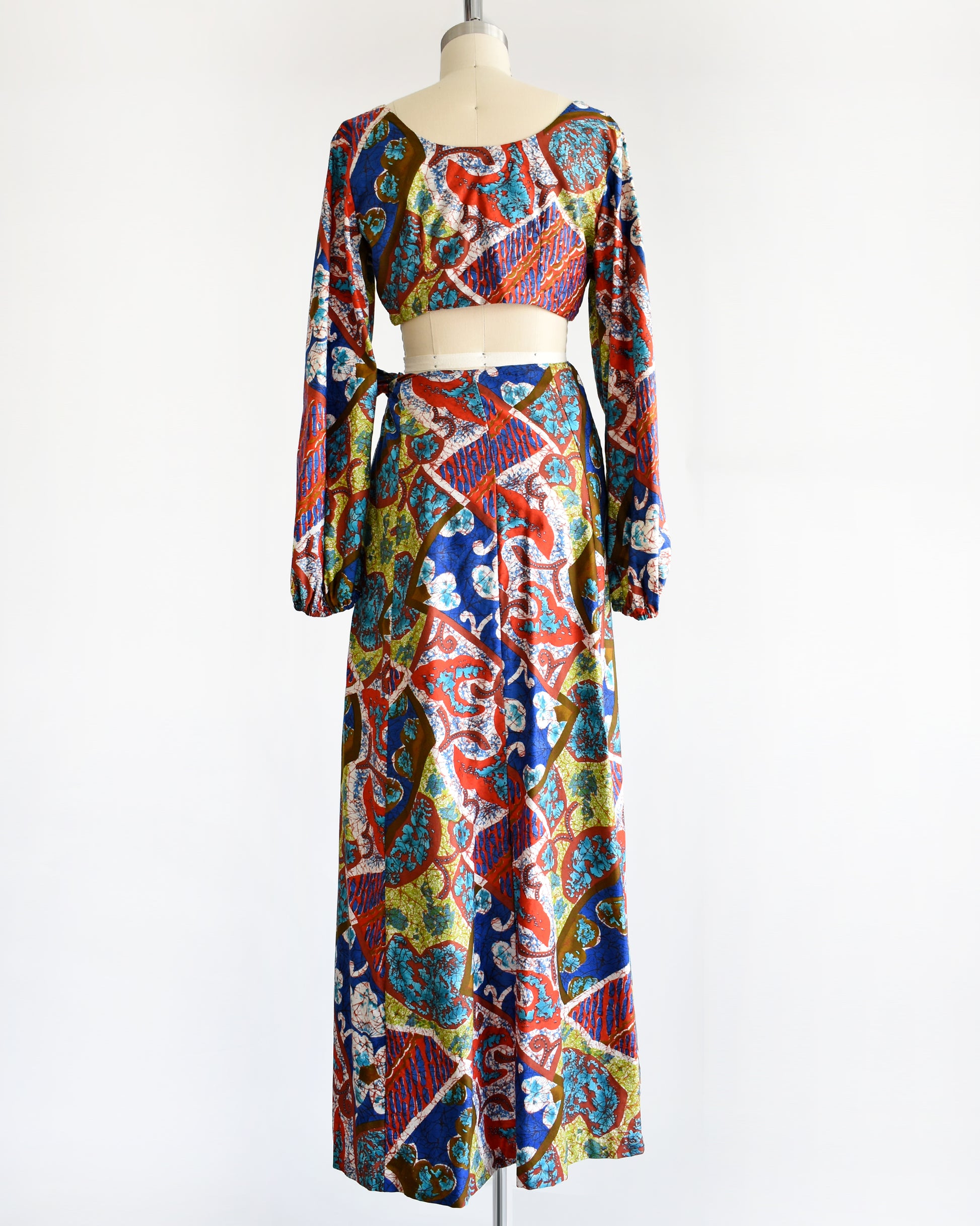 back view of a vintage 1960s/1970s Hawaiian two piece crop top and maxi skirt set by Kahala. 