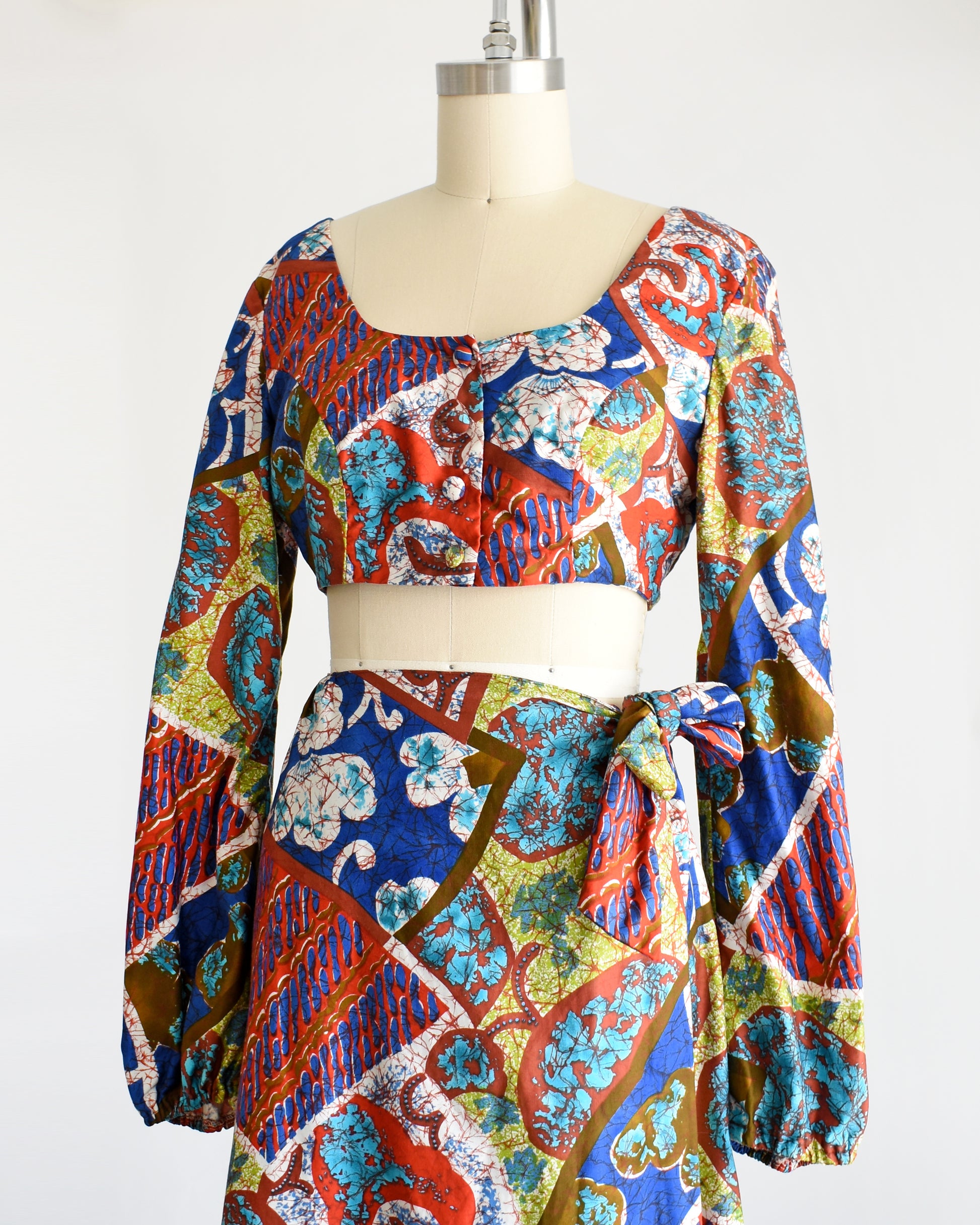 side front view of a vintage 1960s/1970s Hawaiian two piece crop top and maxi skirt set by Kahala. 