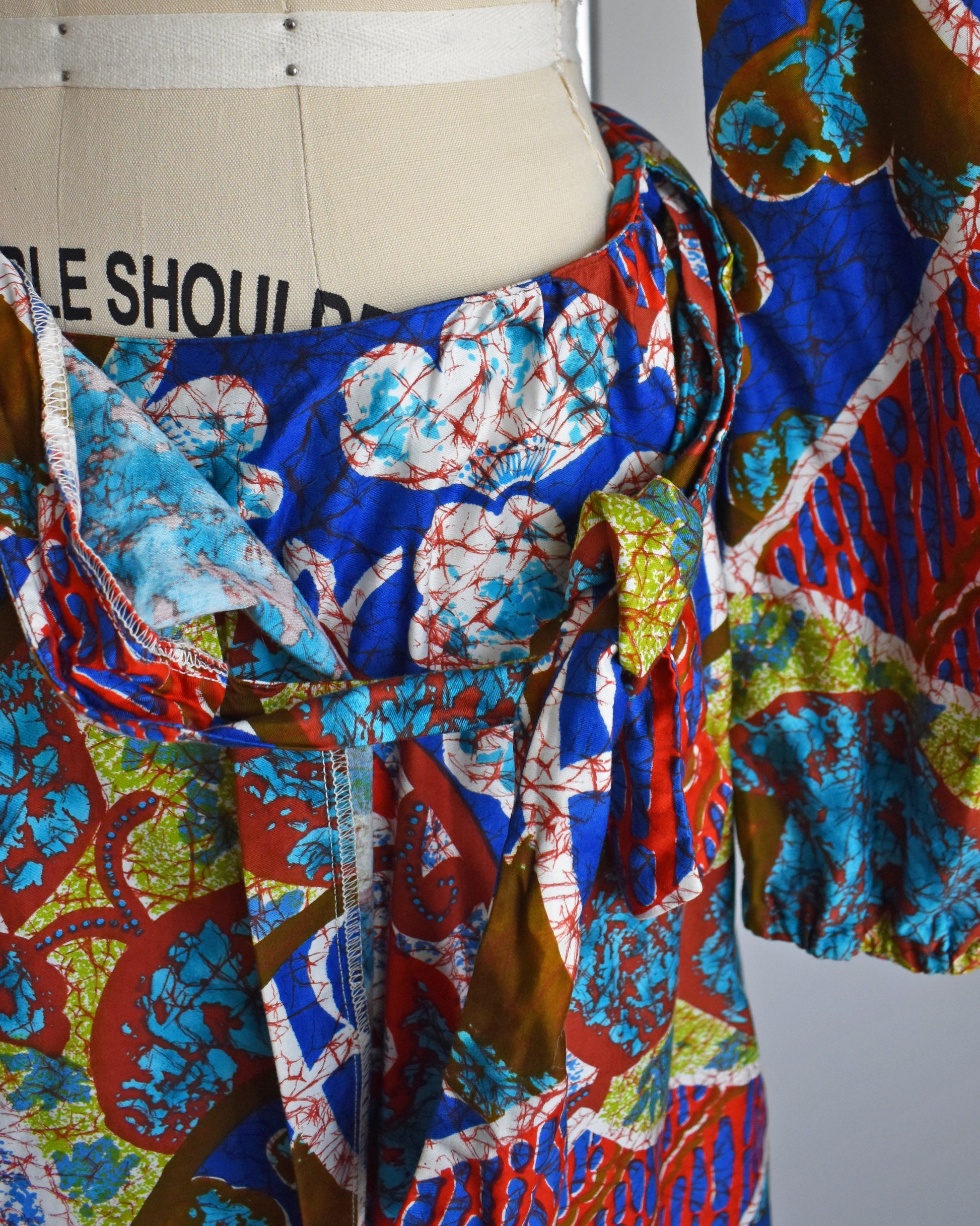 close up of the tied waist on the skirt of a a vintage 1960s/1970s Hawaiian two piece crop top and maxi skirt set by Kahala. 