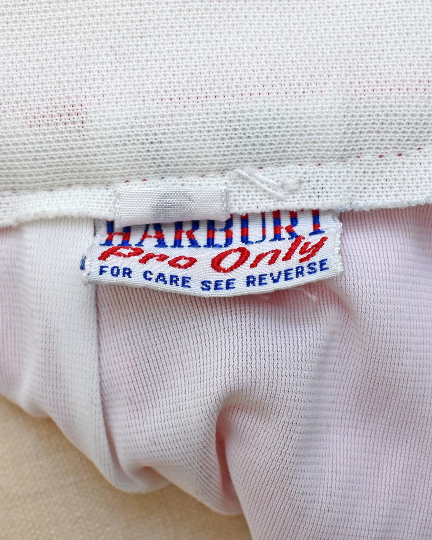 Close-up of a label on a white fabric with text 'Harbort Pro Only'.
