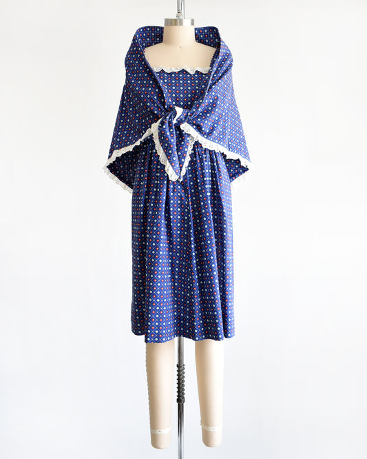 a vintage 1970s navy blue floral sundress with matching shawl on a dress form