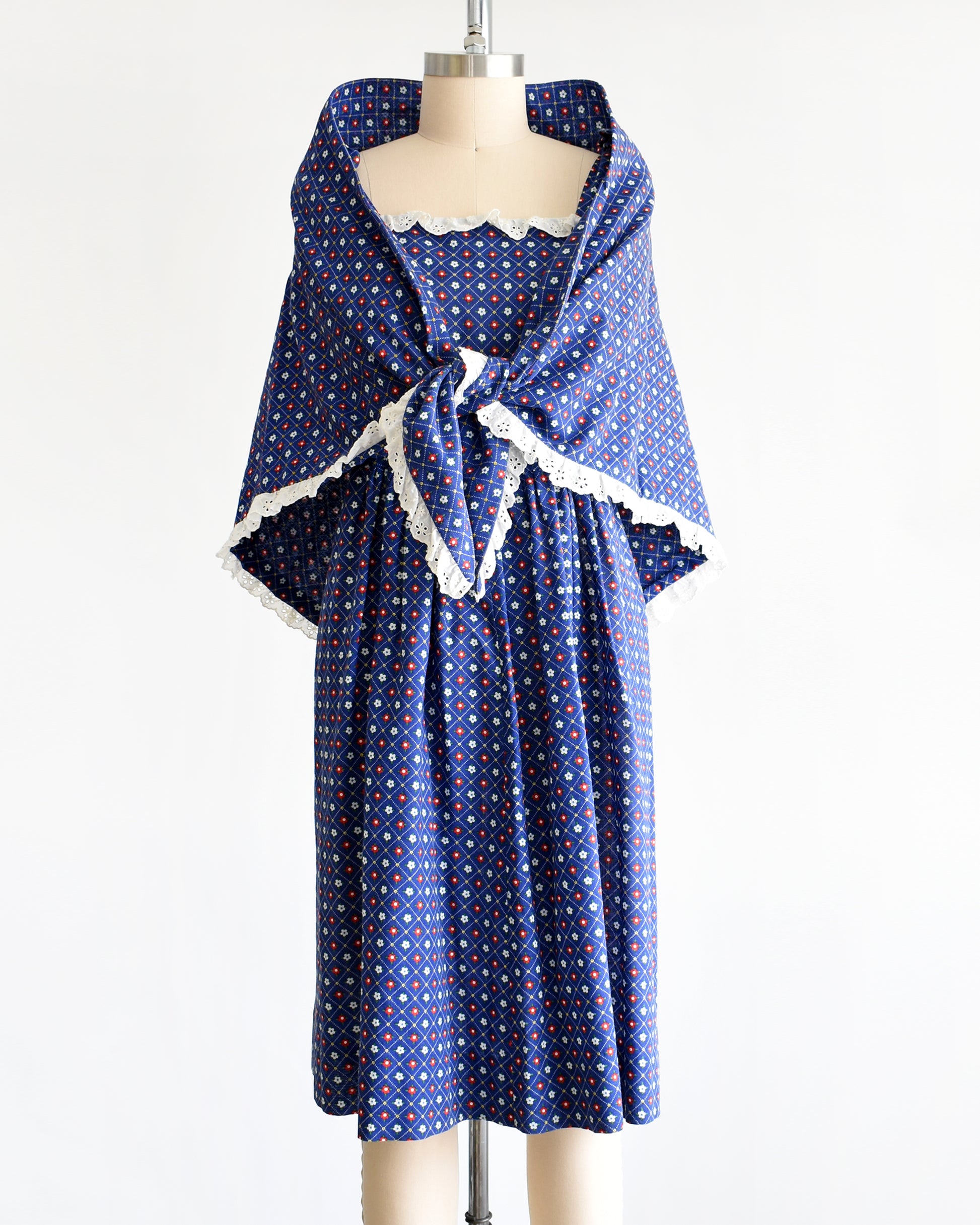 a vintage 1970s navy blue floral sundress with matching shawl on a dress form