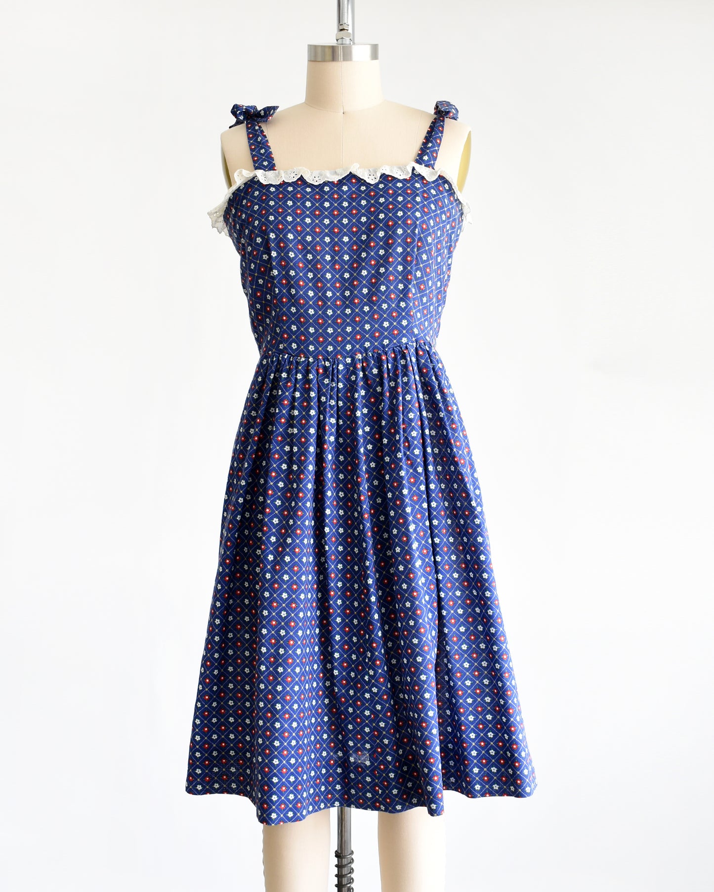 a vintage 1970s navy blue floral sundress on a dress form