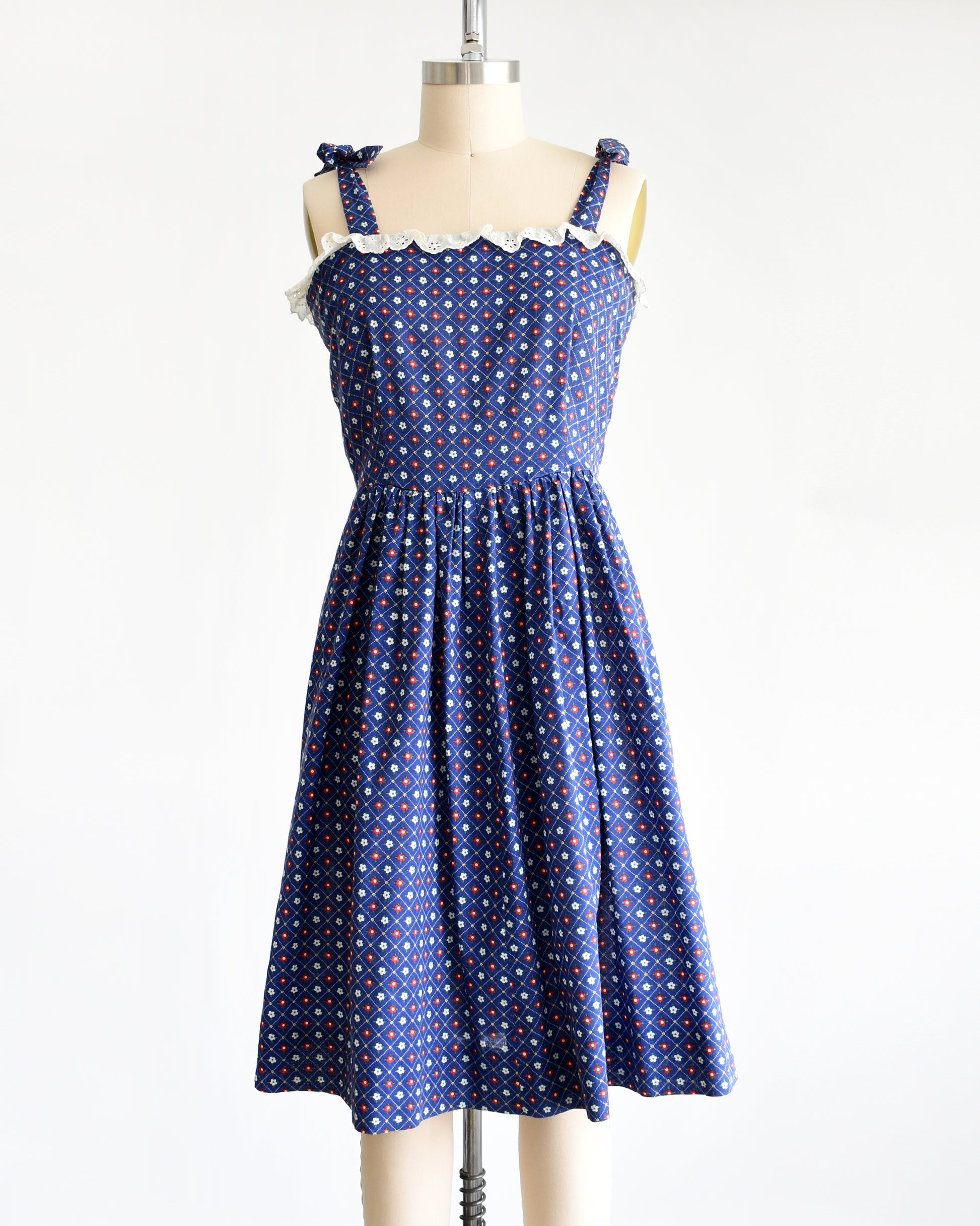 a vintage 1970s navy blue floral sundress on a dress form