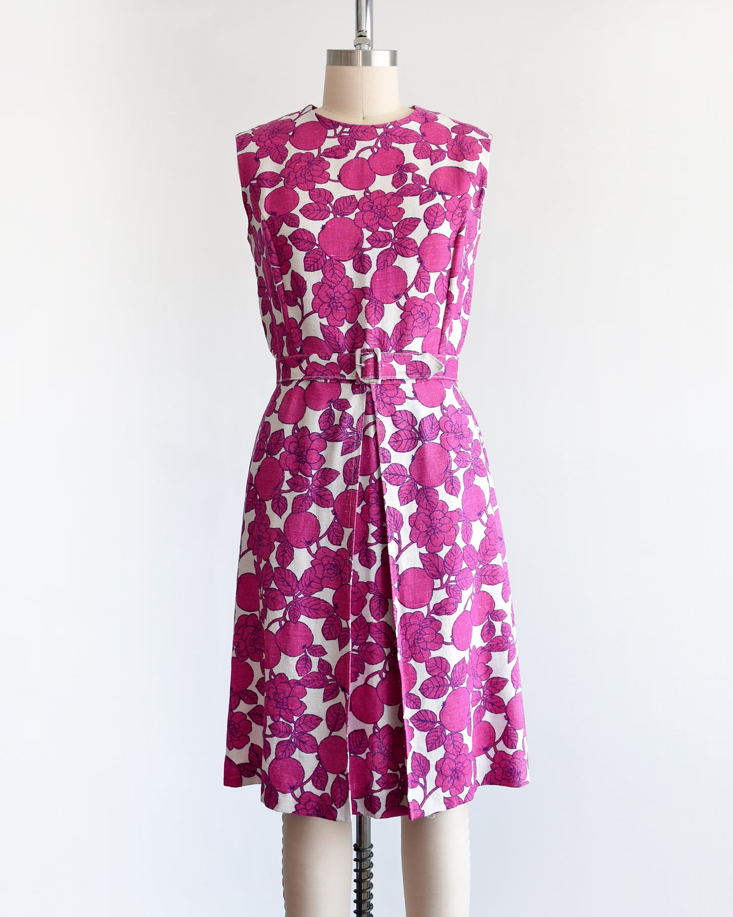A vintage 1960s magenta and white floral and fruit print dress
