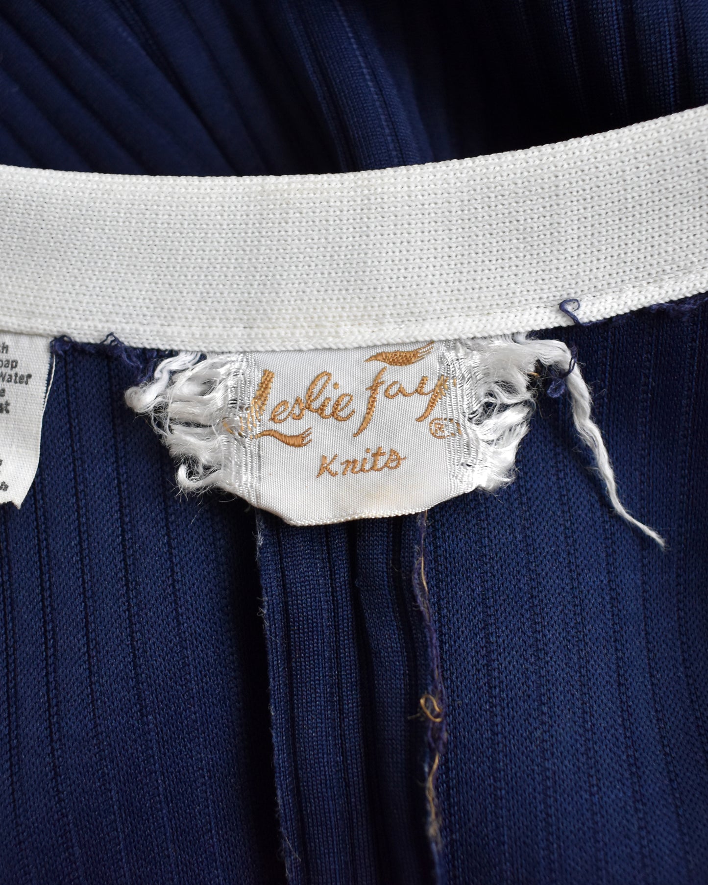 Navy blue knitted garment with a visible 'Leslie Fay Knits' label.