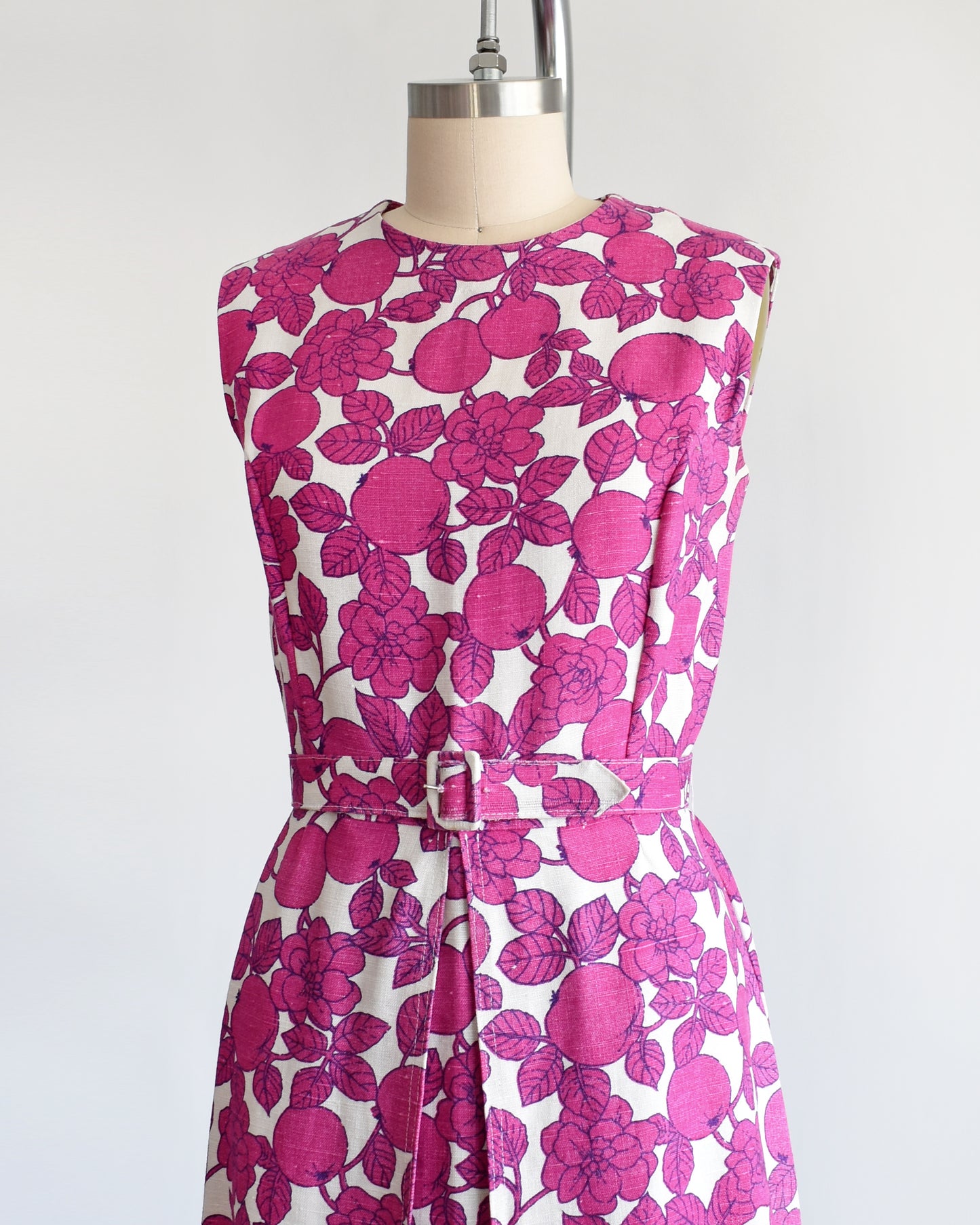 side front view of a vintage 1960s magenta and white floral and fruit print dress
