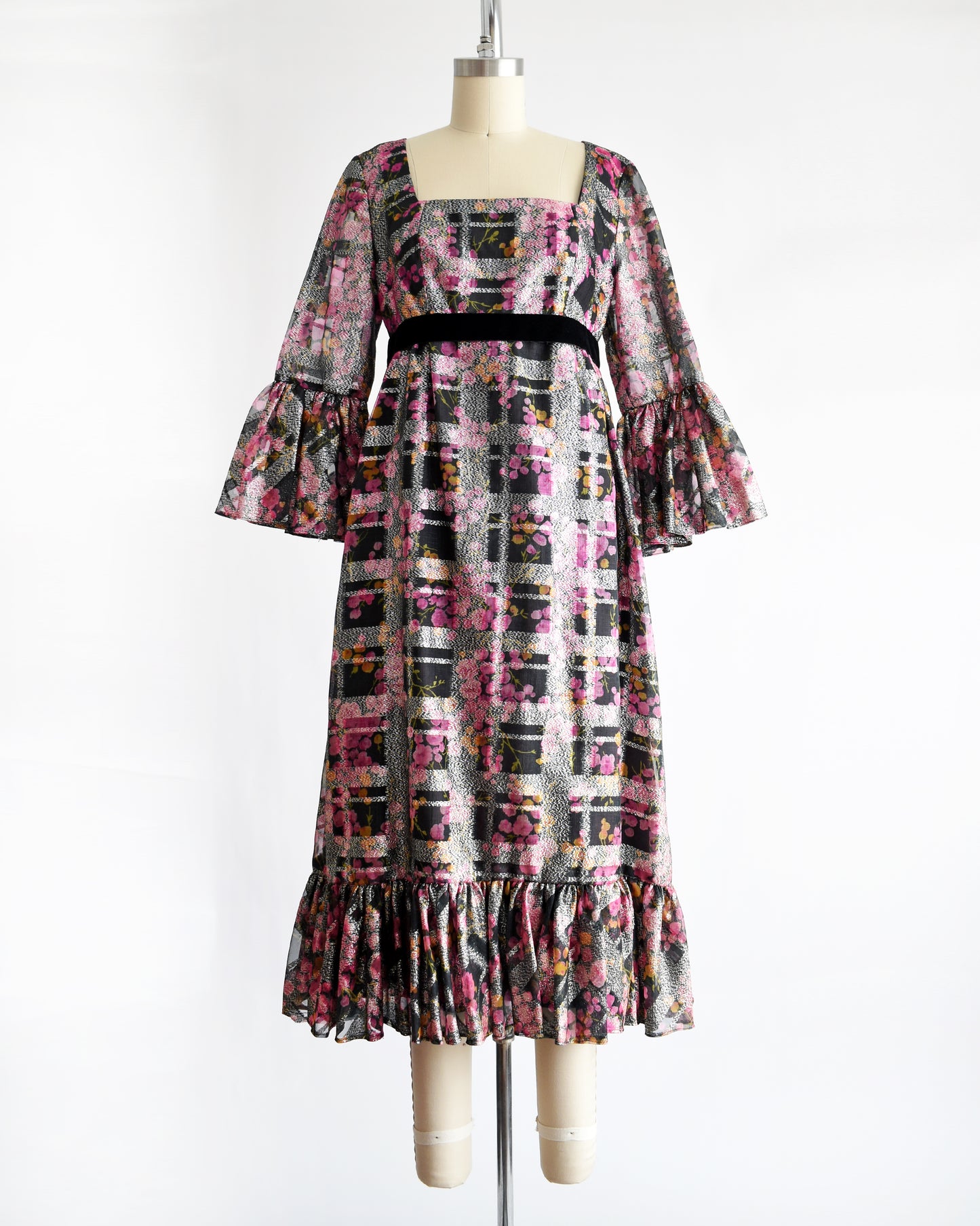 a vintage 1970s pink and black floral Victor Costa dress on a mannequin against a white background