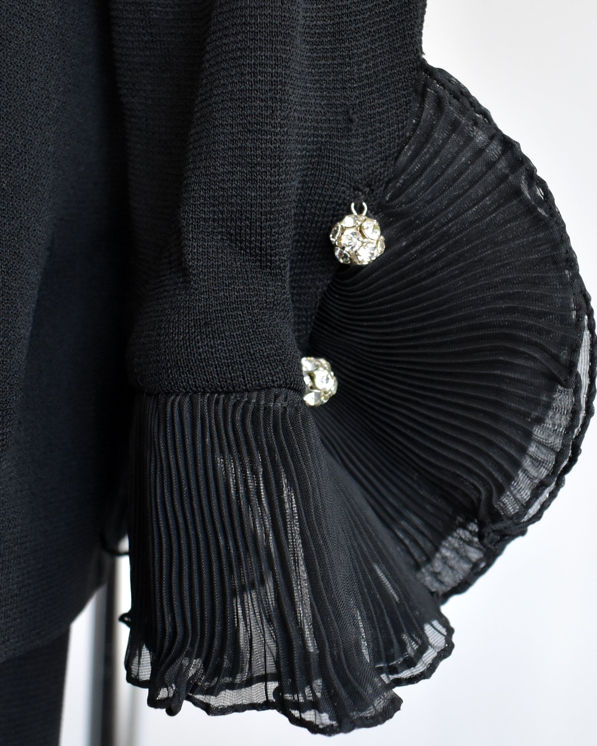 close up of the rhinestone buttons on the sleeve cuffs