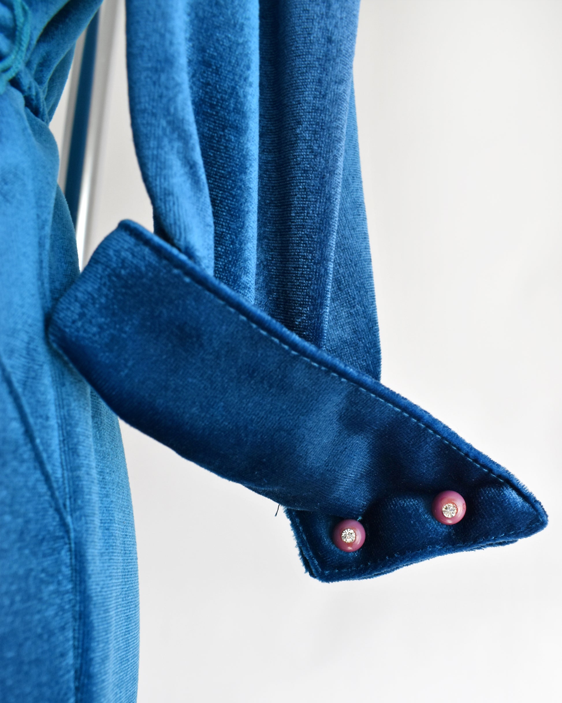 Close-up of of the buttons on the cuffs on a white background