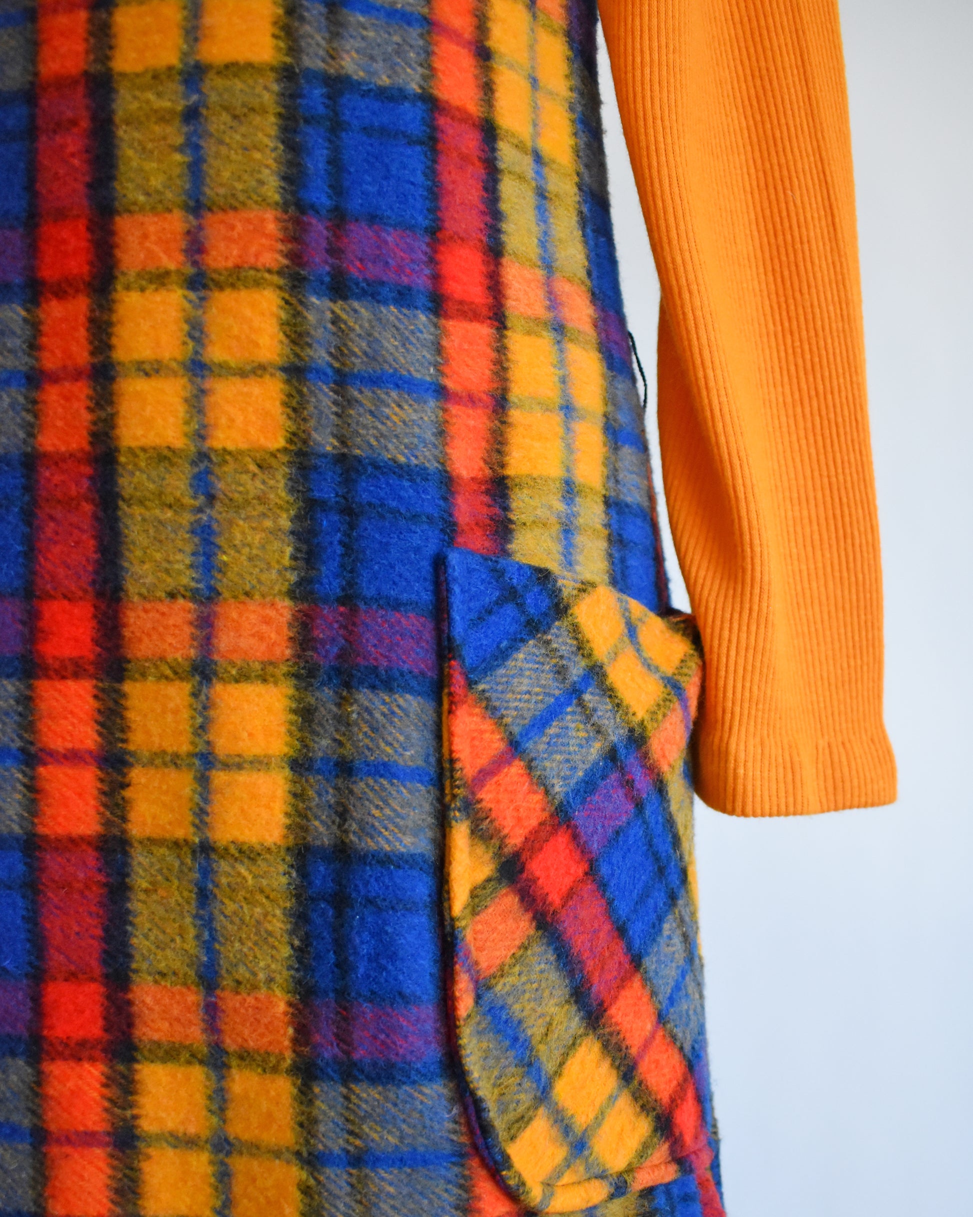 close up of the plaid dress and the pocket on the front