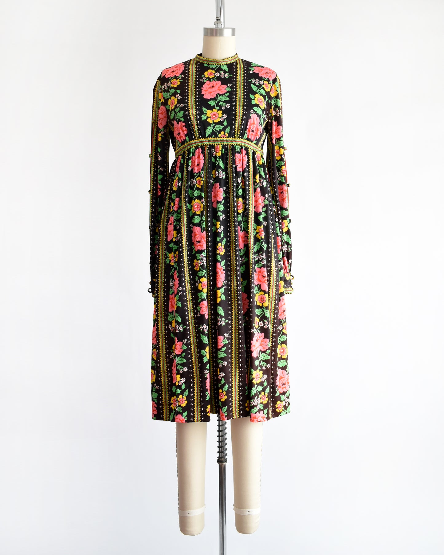 a vintage 1960s/1970s floral dress on a mannequin against a white background