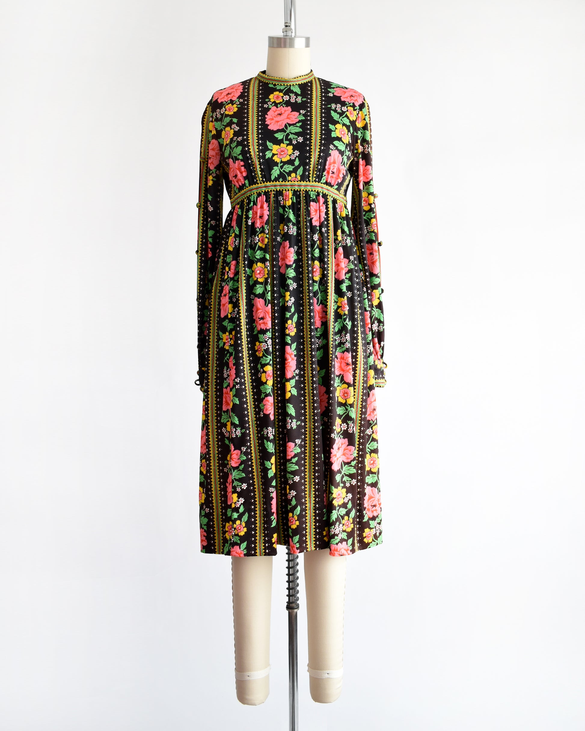 a vintage 1960s/1970s floral dress on a mannequin against a white background