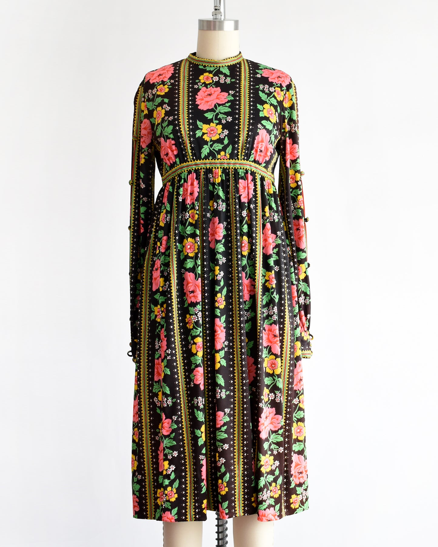 a vintage 1960s/1970s floral dress on a mannequin against a white background