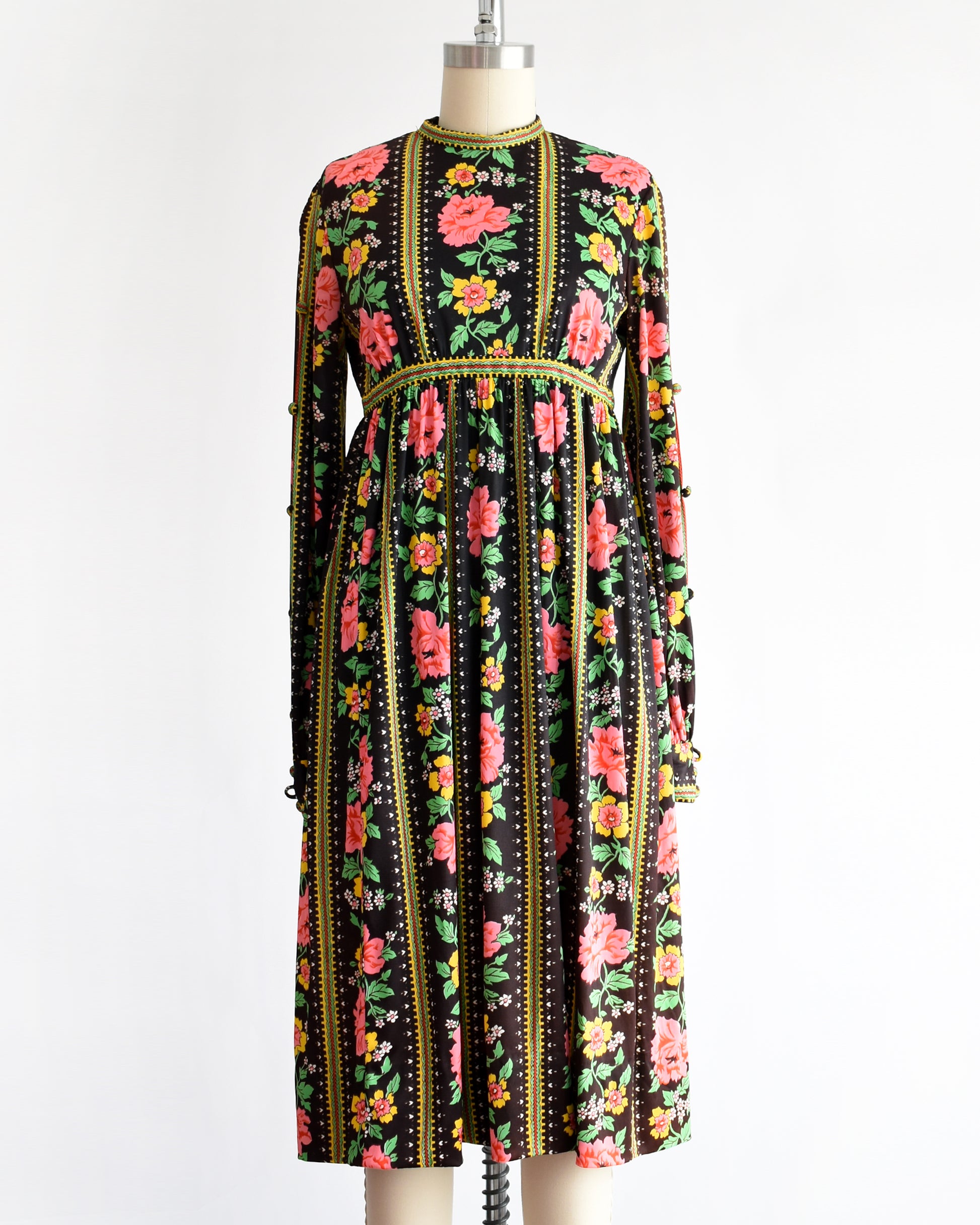 a vintage 1960s/1970s floral dress on a mannequin against a white background