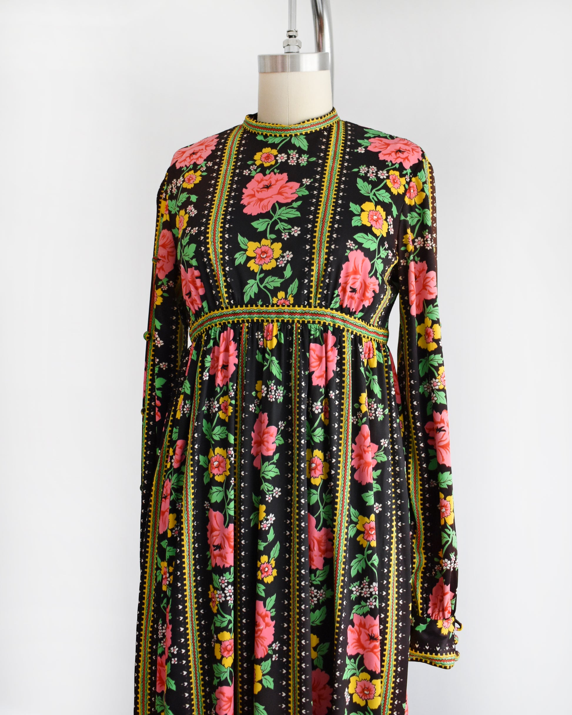 side front view of a vintage 1960s/1970s floral dress on a mannequin against a white background