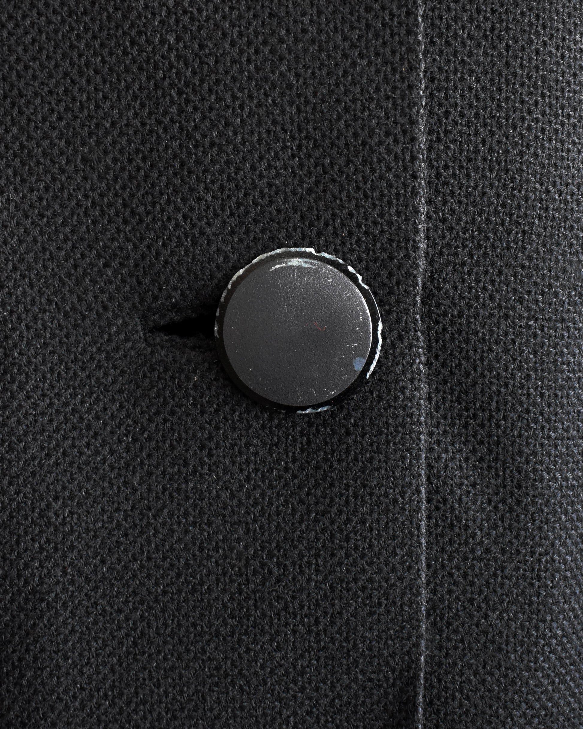 close up of the bottom button which shows some wear on it