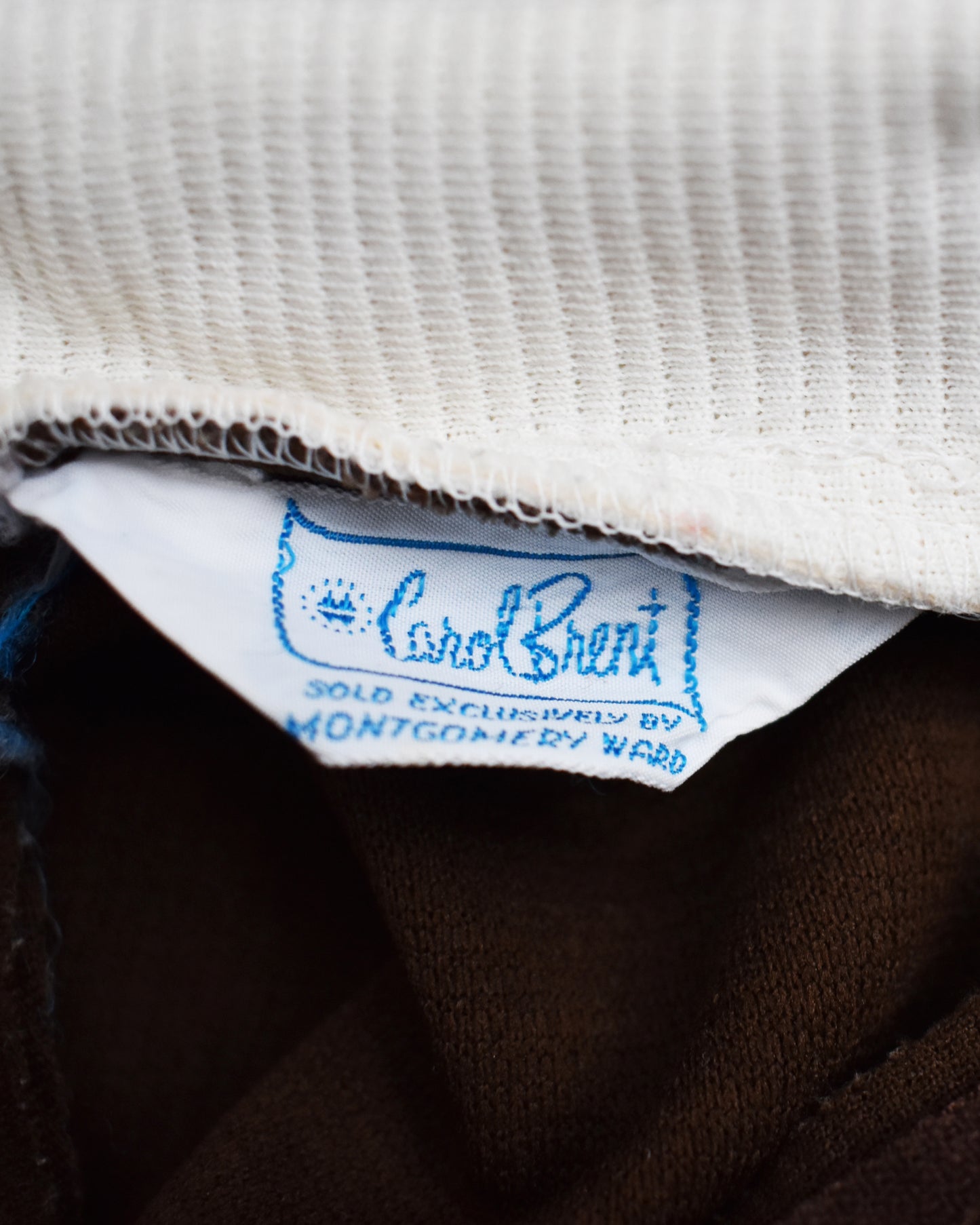 Close-up of a label on a garment with 'Carol Brent' branding.