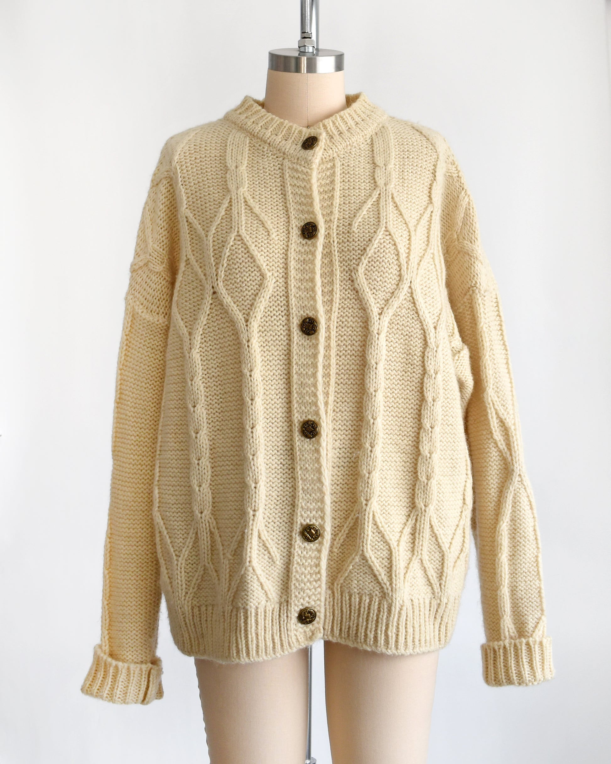 a vintage 1990s cream cable knit wool cardigan