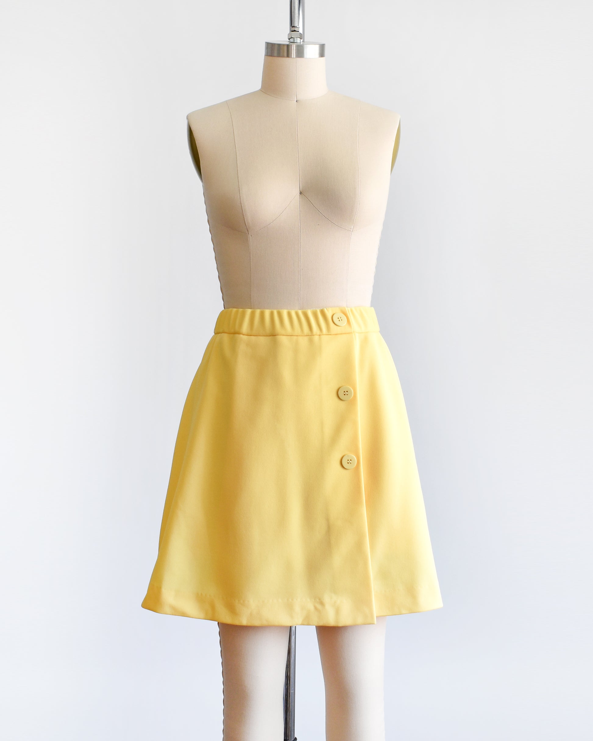 a vintage 1970s skort with three decorative buttons along the left side