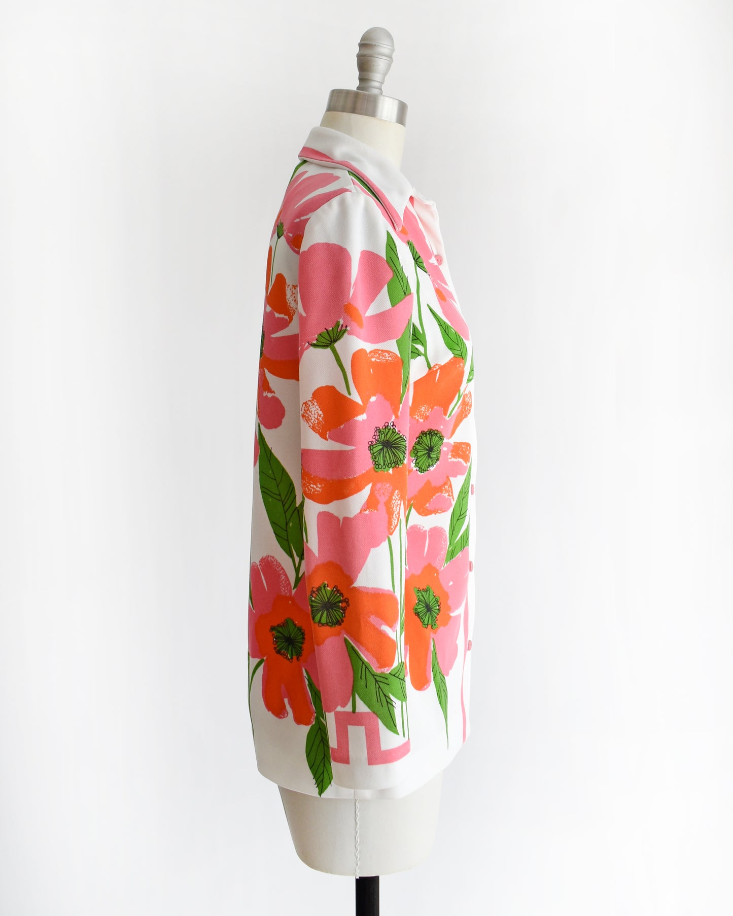 side view of a vintage 1970s floral patterned Vera shirt on a mannequin against a white background