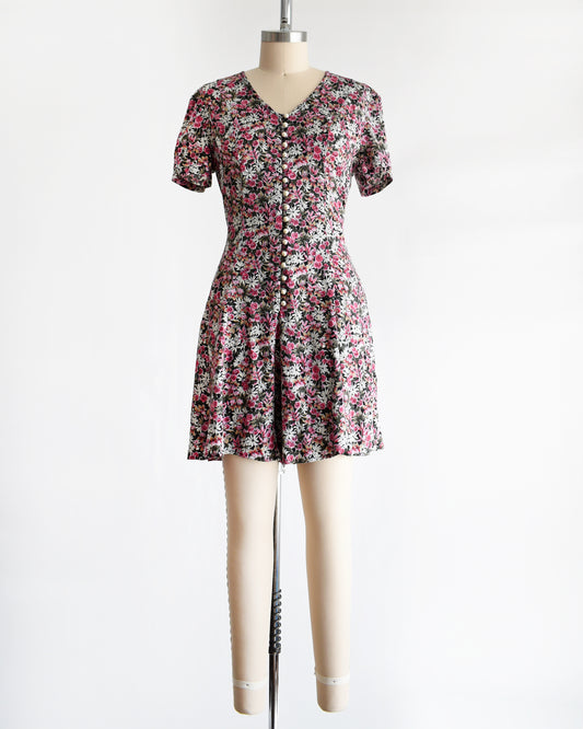 a vintage 1990s floral romper on a mannequin against a white background