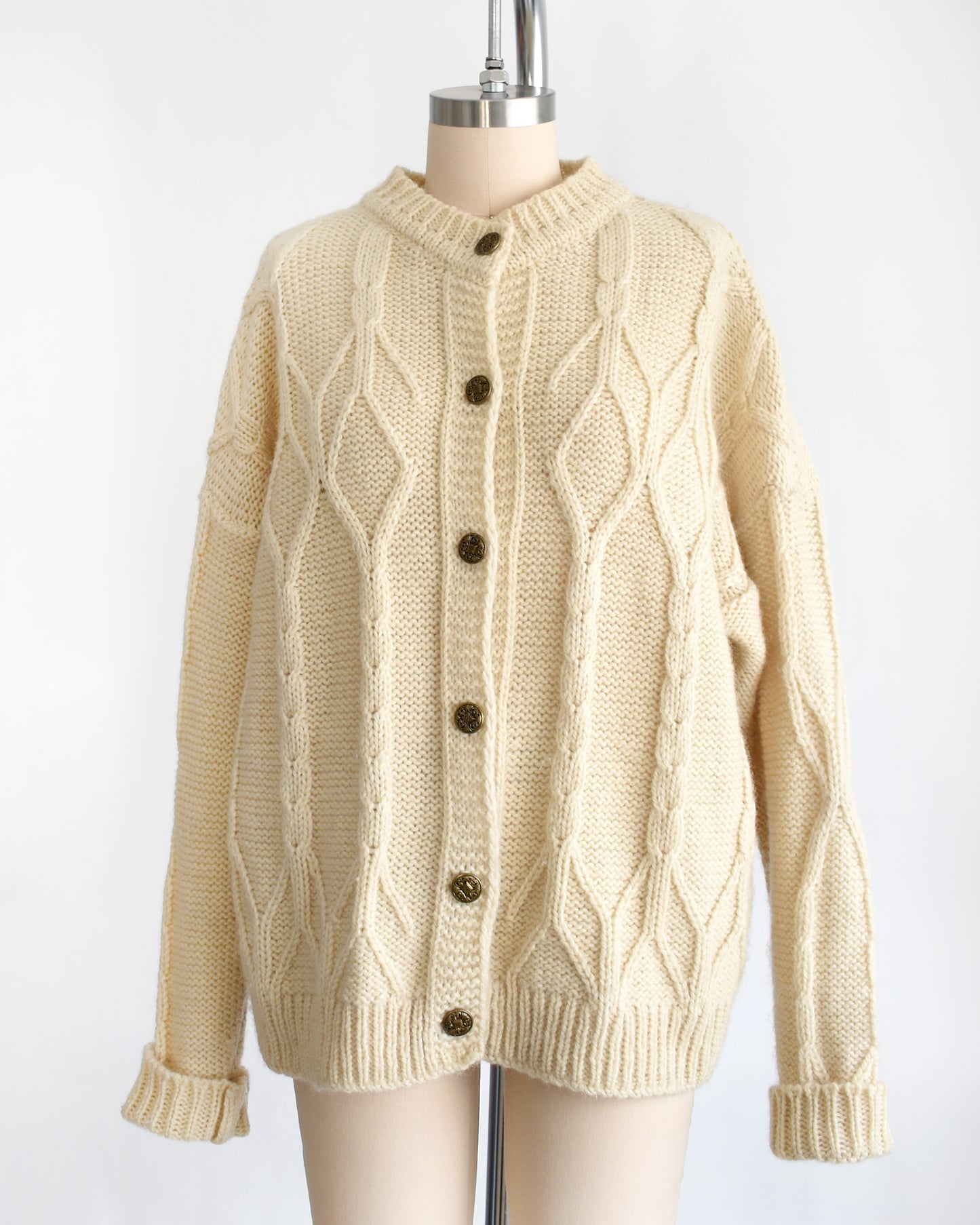 side front view of a vintage 1990s cream cable knit wool cardigan