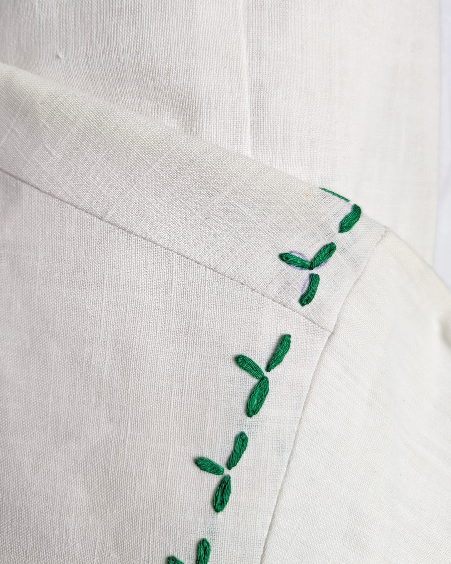 close up of the left shoulder showing some small flaws, including a spot and a pen outline.