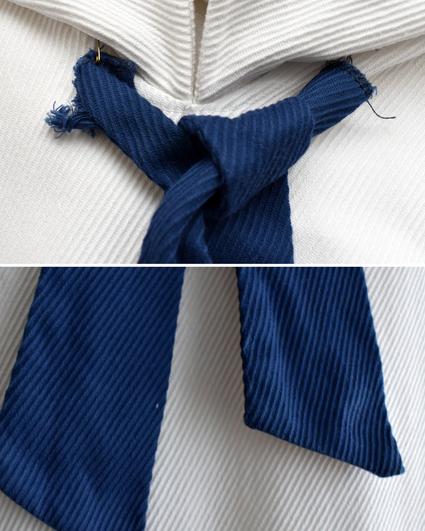 close up of the safety pinned tie and small white spot on the tie
