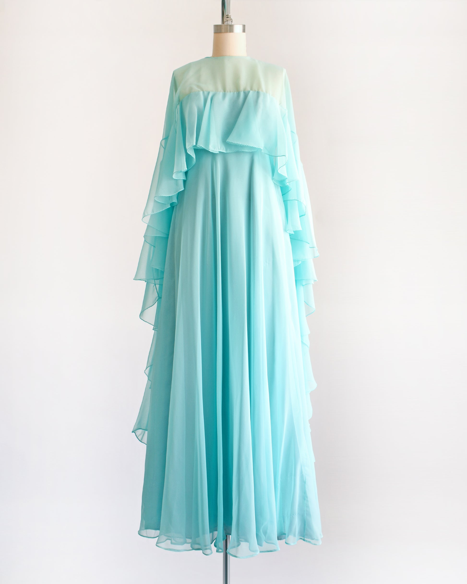 a vintage 1960s light blue ruffled maxi dress on a mannequin against a white background