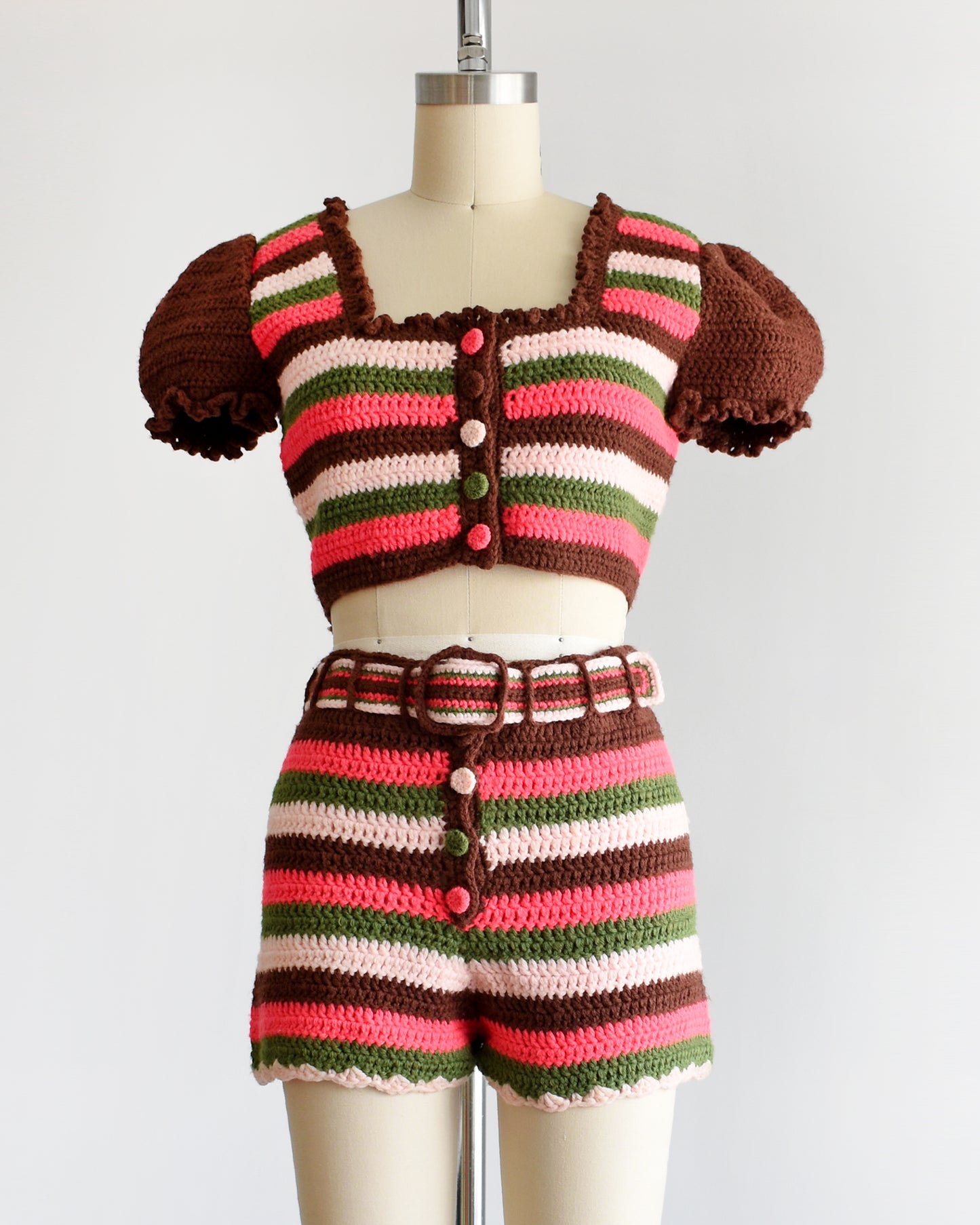 a vintage 1970s  striped knit crop top and hot pant shorts on a mannequin against a white background