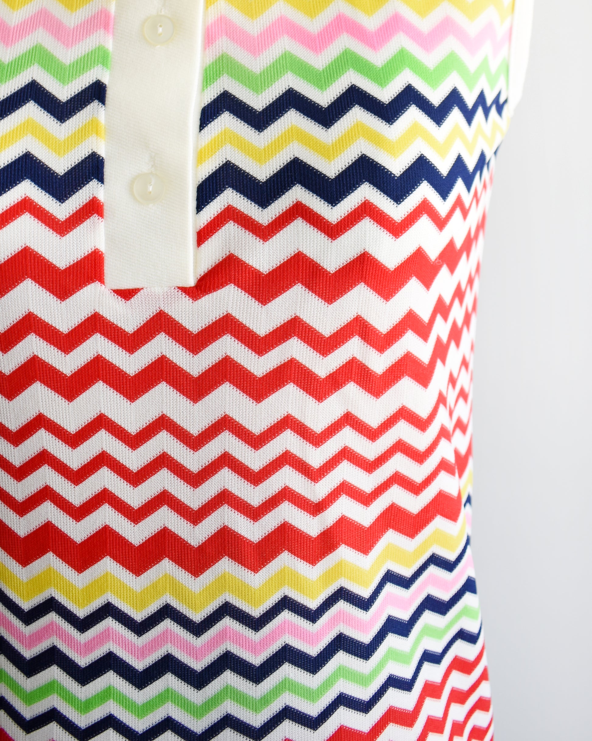 close up of a vintage 1970s colorful zigzag patterned sleeveless top on a mannequin against a white background