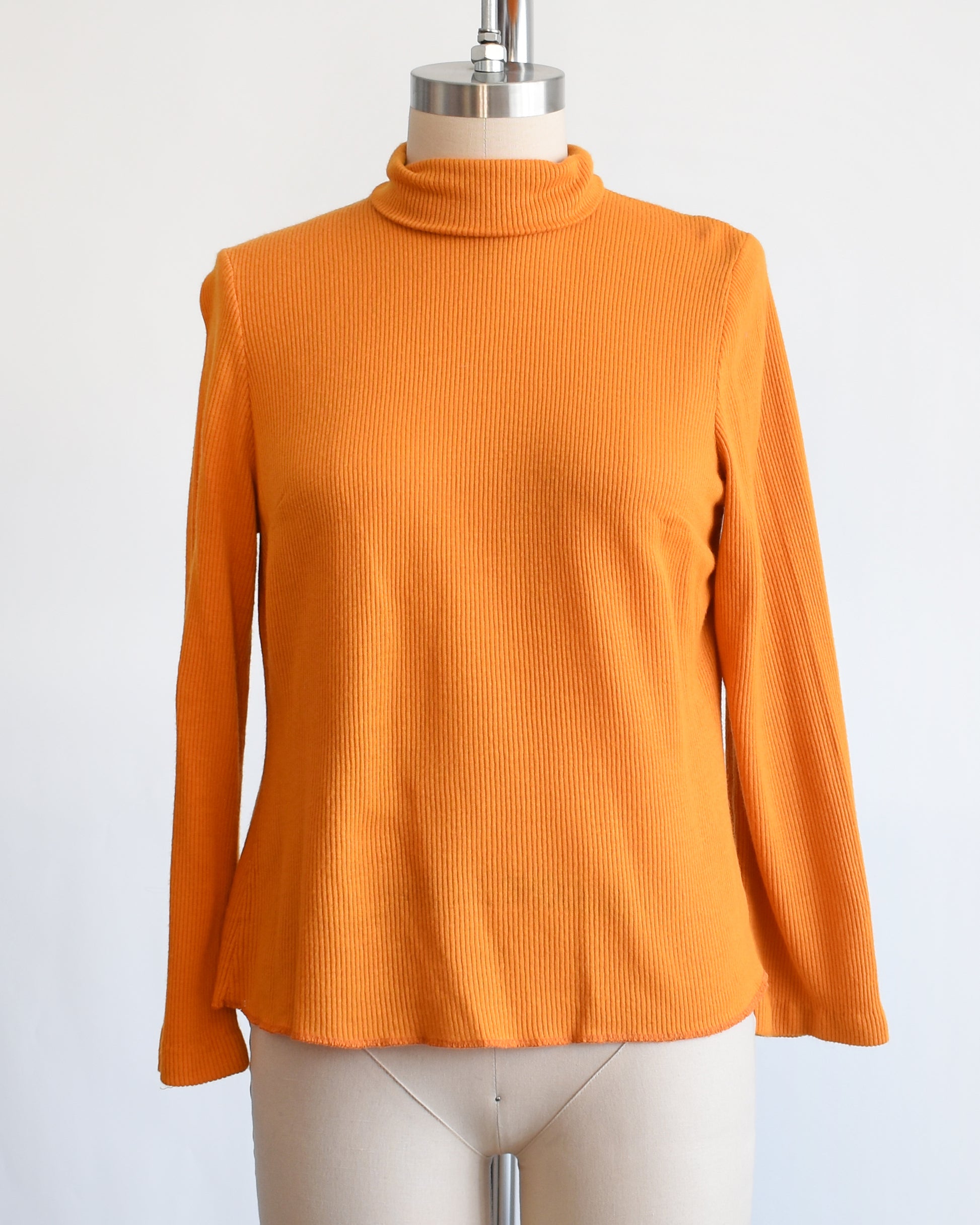 The ribbed orange turtleneck on a dress form