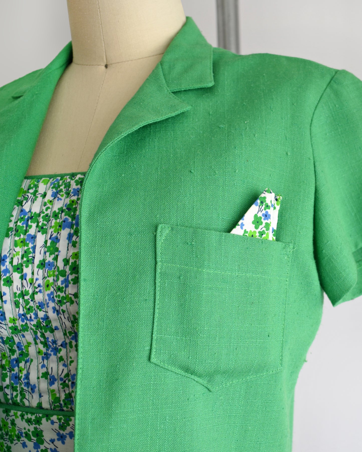 close up of the green bolero and pocket square