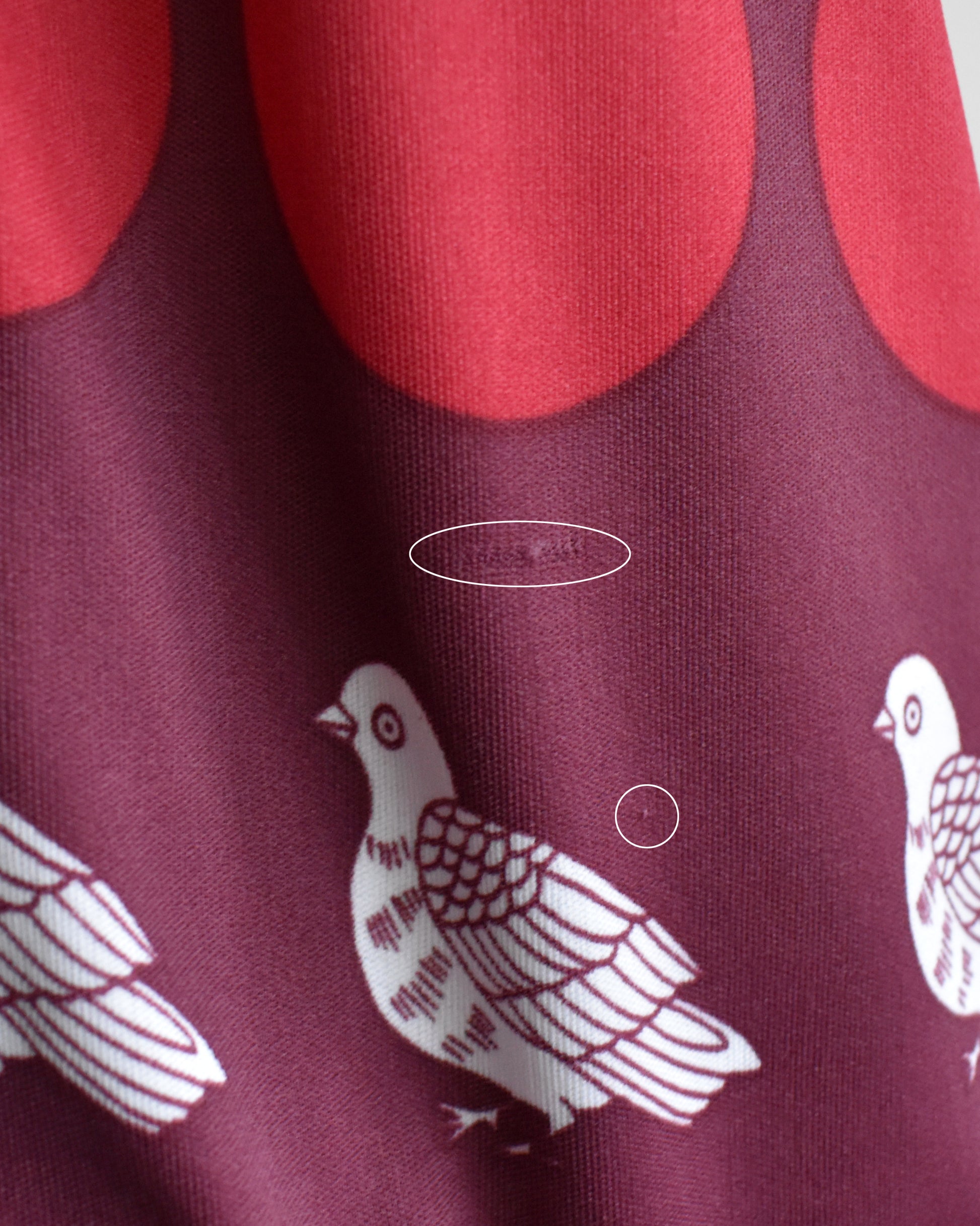 close up of the shirt which has small snags circled.