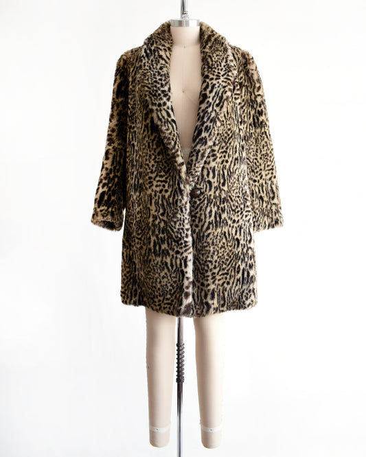 a vintage 1980s faux fur leopard print coat on a mannequin against a white background