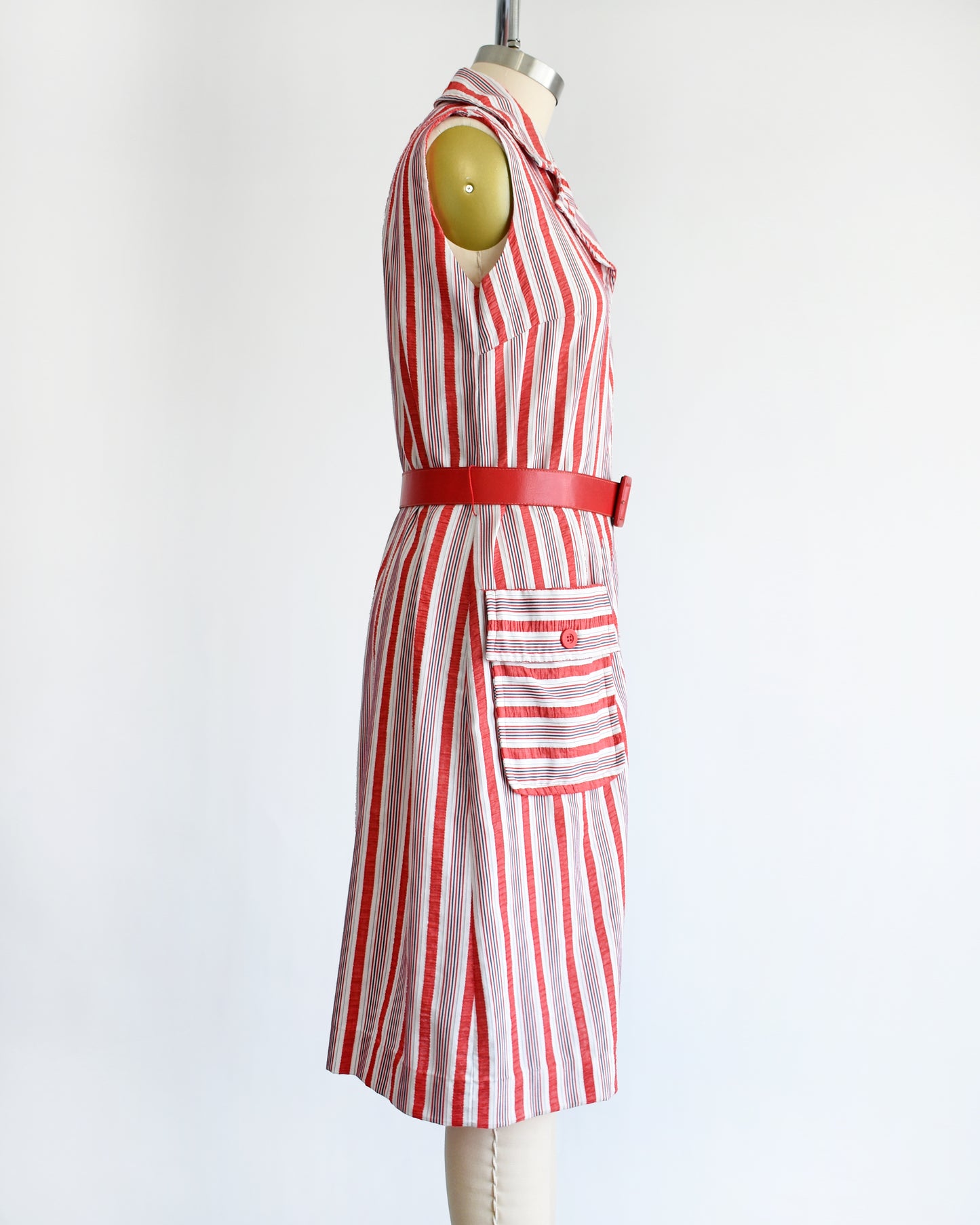 side view of a vintage 1970s red and white striped dress on a mannequin against a white background