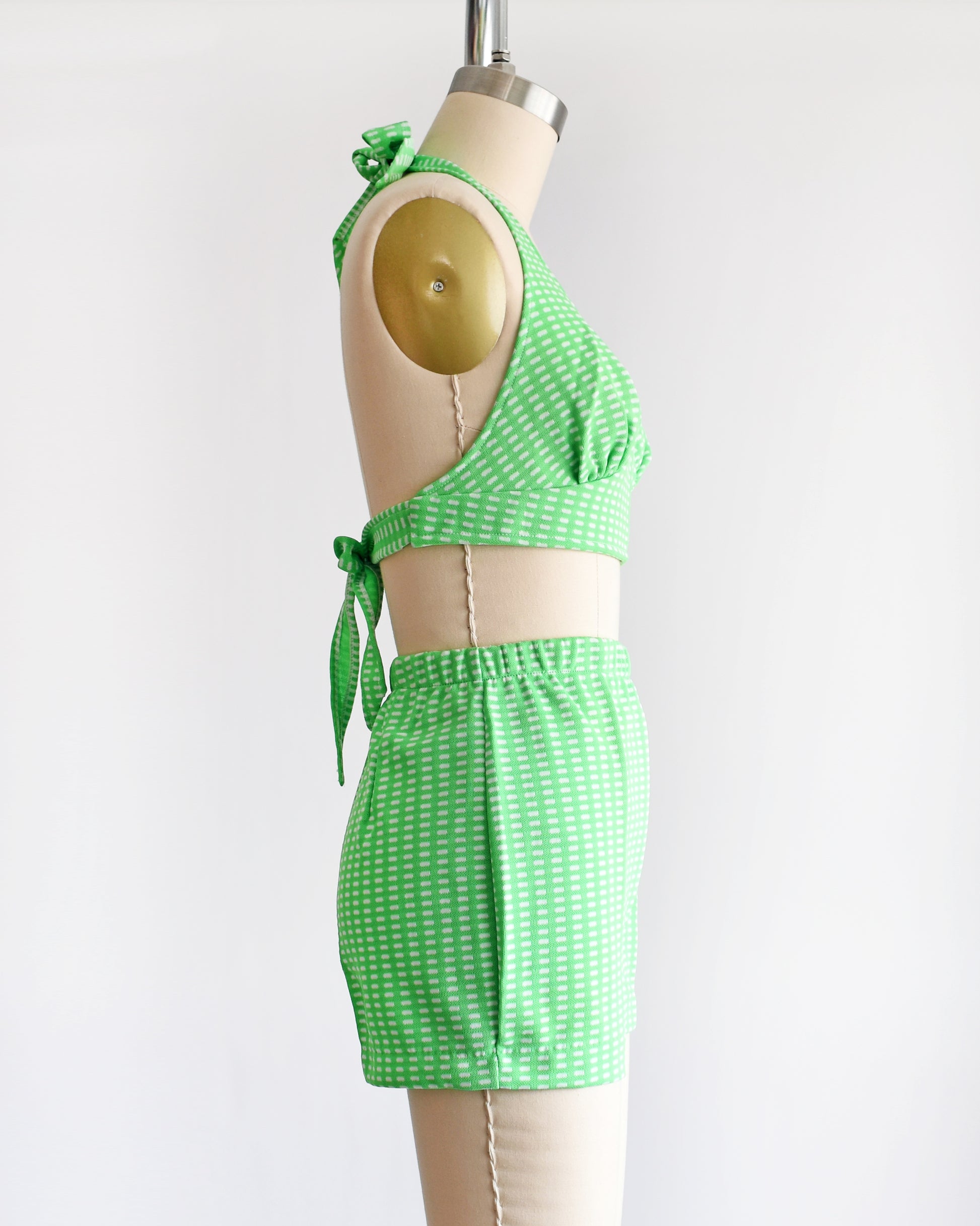 side view of a vintage 1970s green two piece halter top and short set